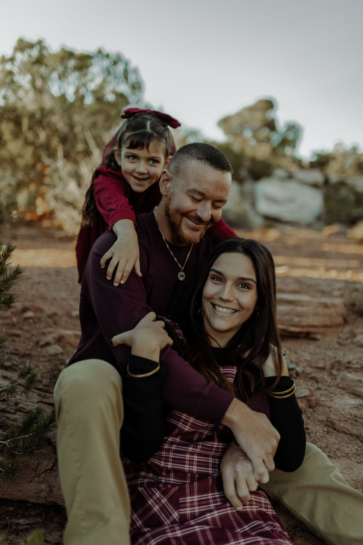 family photo session at the colorado national monument, they are all piled up and hugging, smiling at each other and the camera