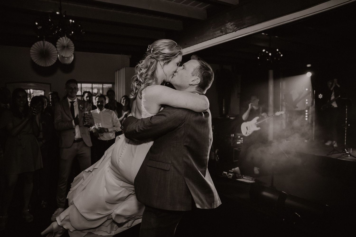 Black and white photo of dancing couple during romantic wedding reception.