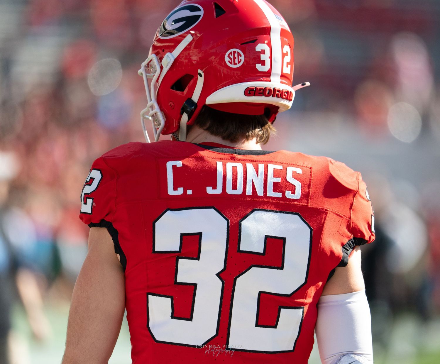 A Georgia football player wearing jersey number 32 stands on the field.