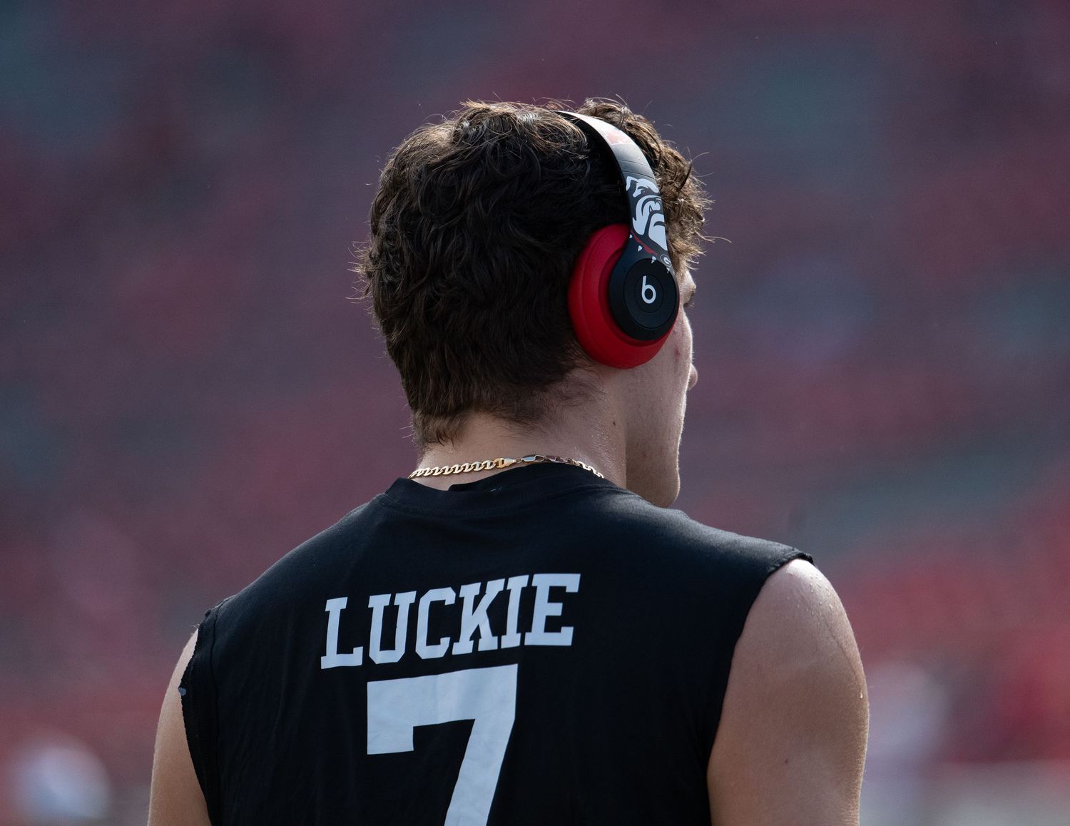 Close-up shots of sports jerseys and players on a field showing uniform numbers and team details.