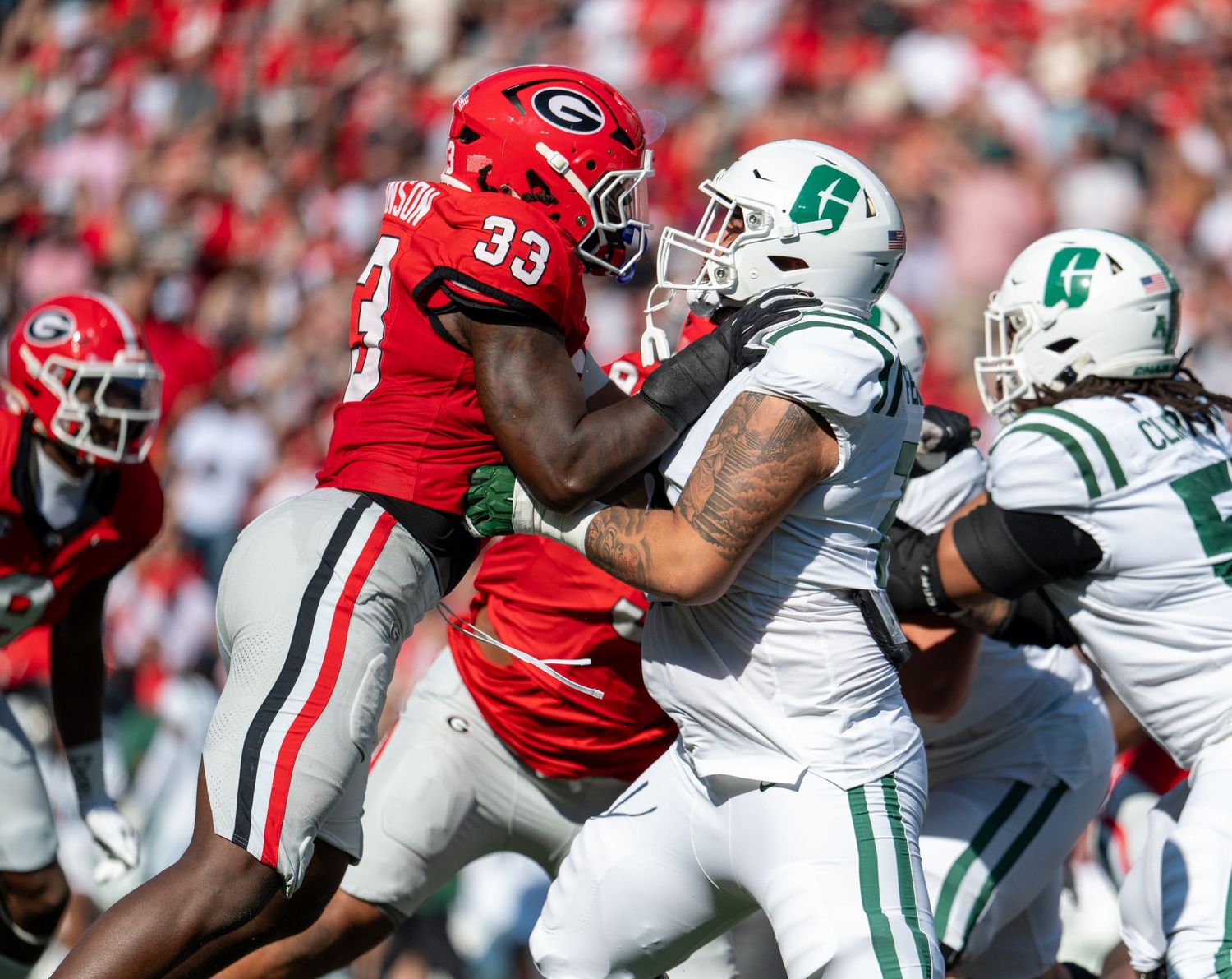 Football players from opposing teams clash during an intense game play.