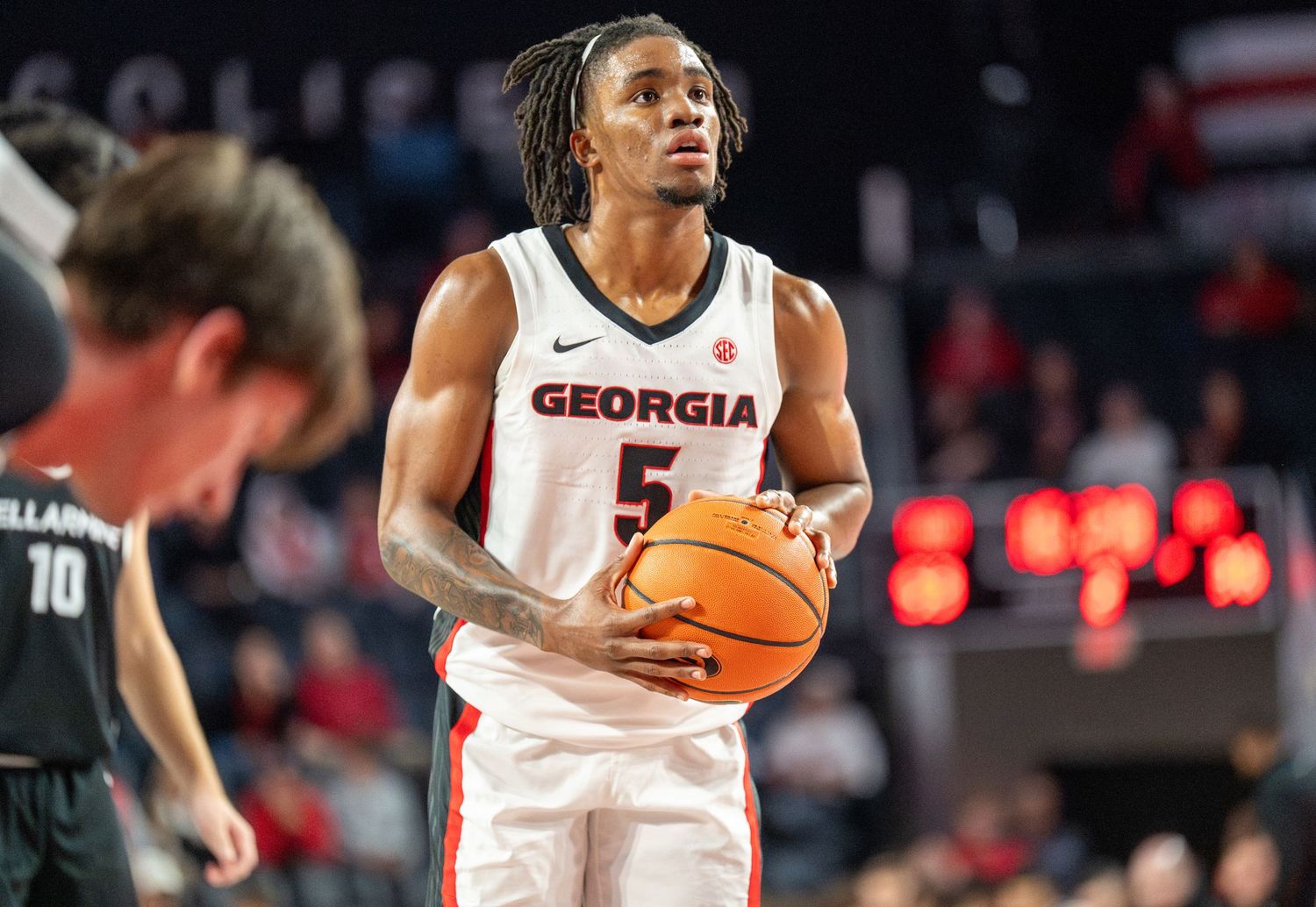 Basketball players in Georgia uniforms compete during a game.