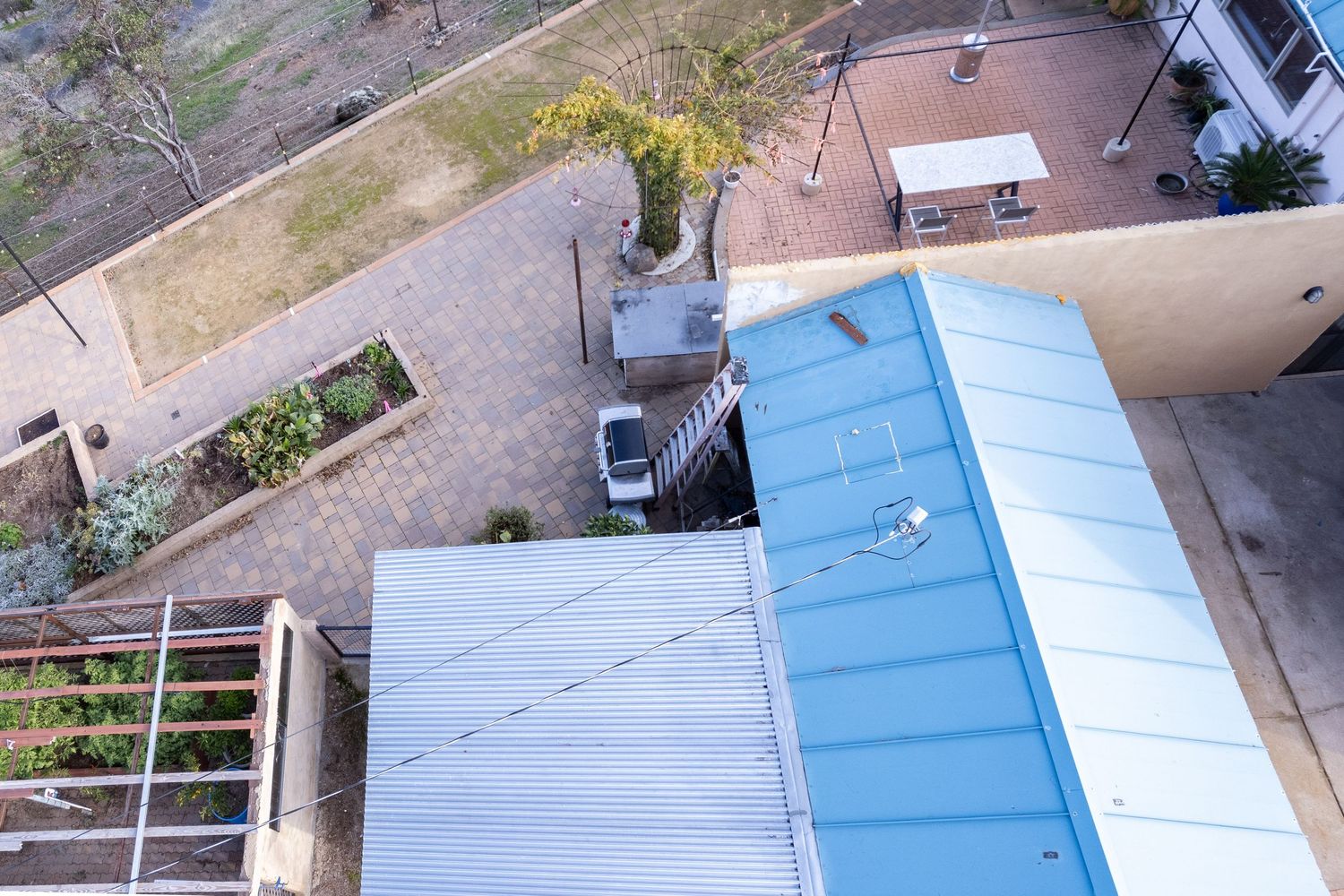 Overhead view of flat roof section with HVAC equipment Forest Ranch California. Elevated drone shot