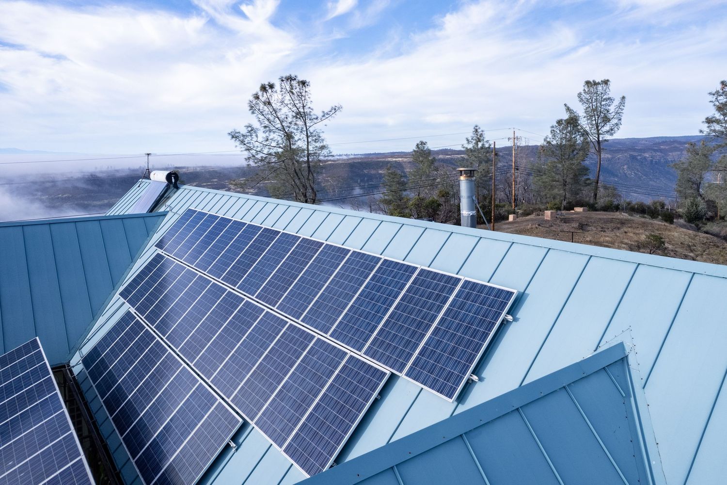 Drone inspection image showing solar panel condition on blue metal residential roof