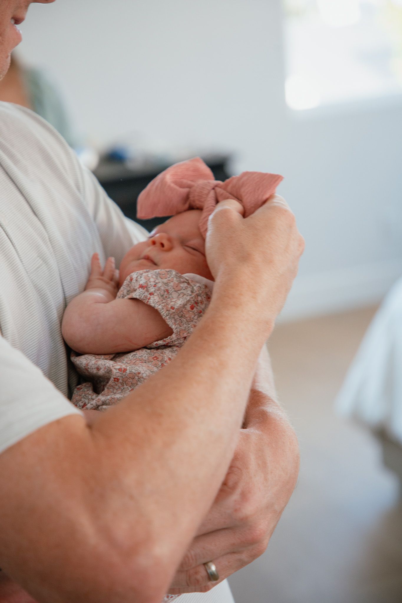 father holding newborn baby daughter