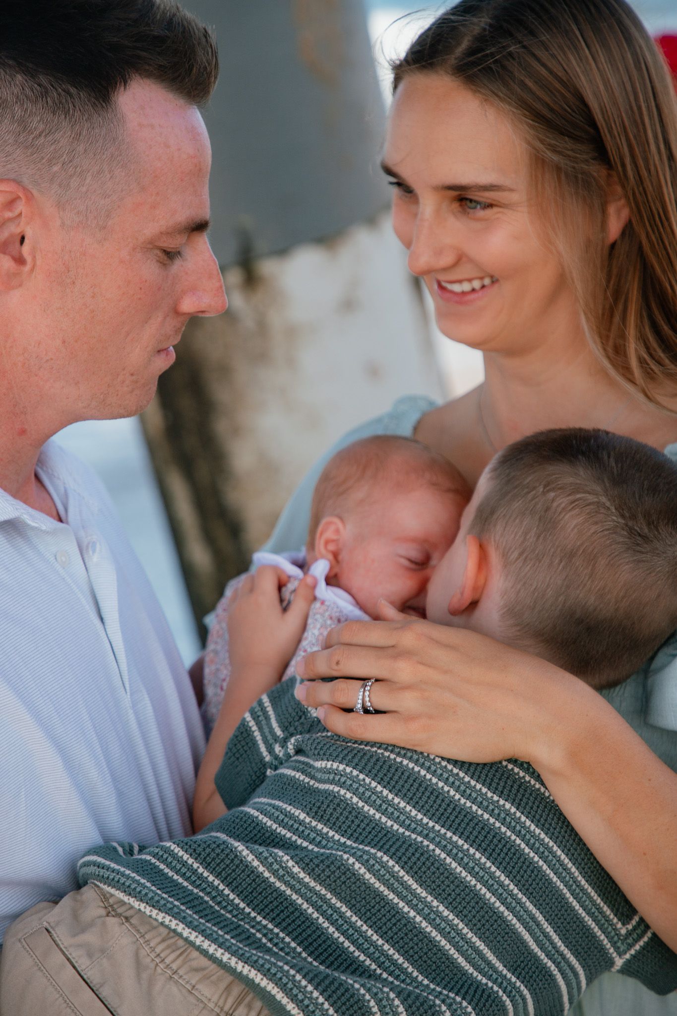 family with newborn and toddler under the beach pier