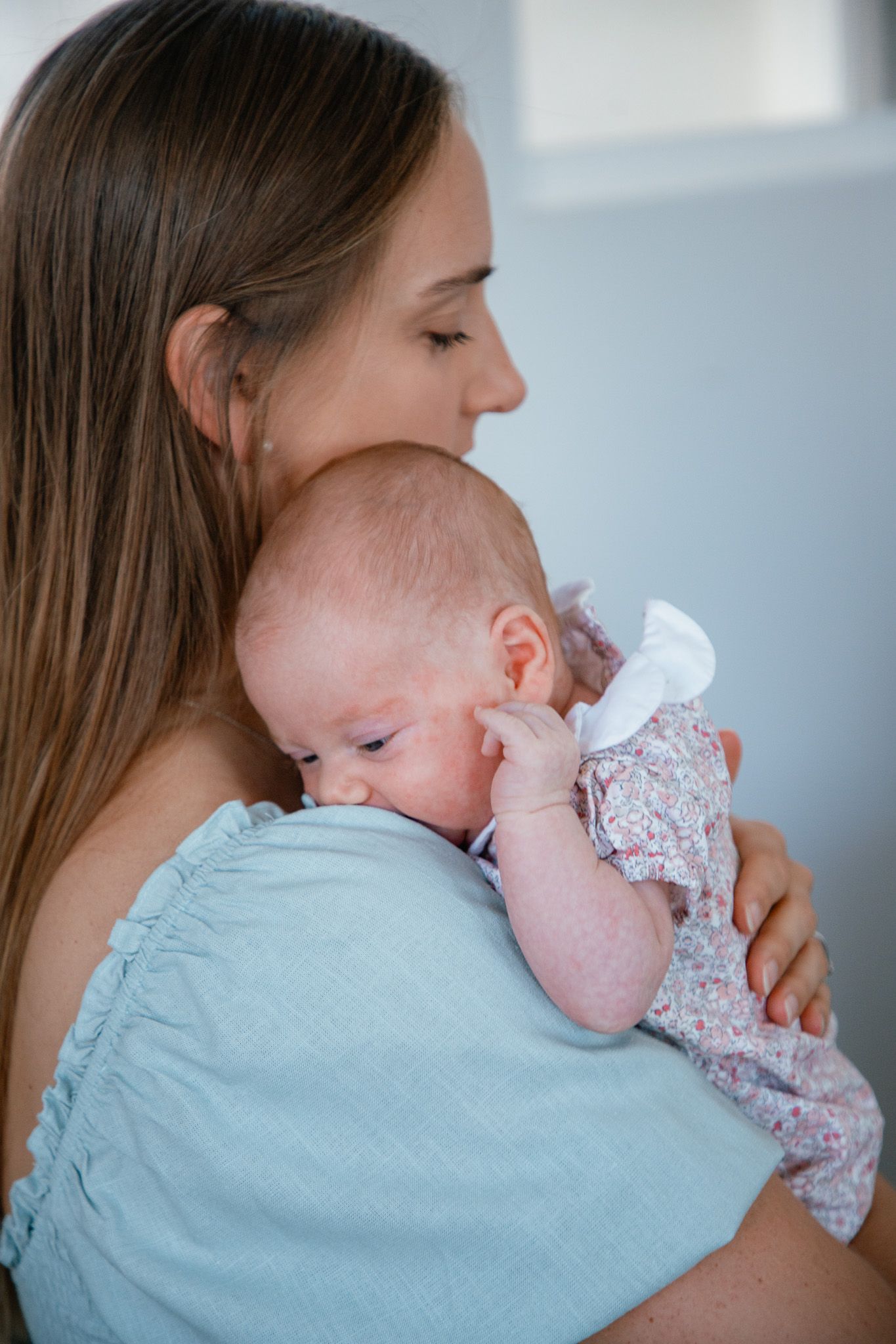 mom holding newborn baby girl
