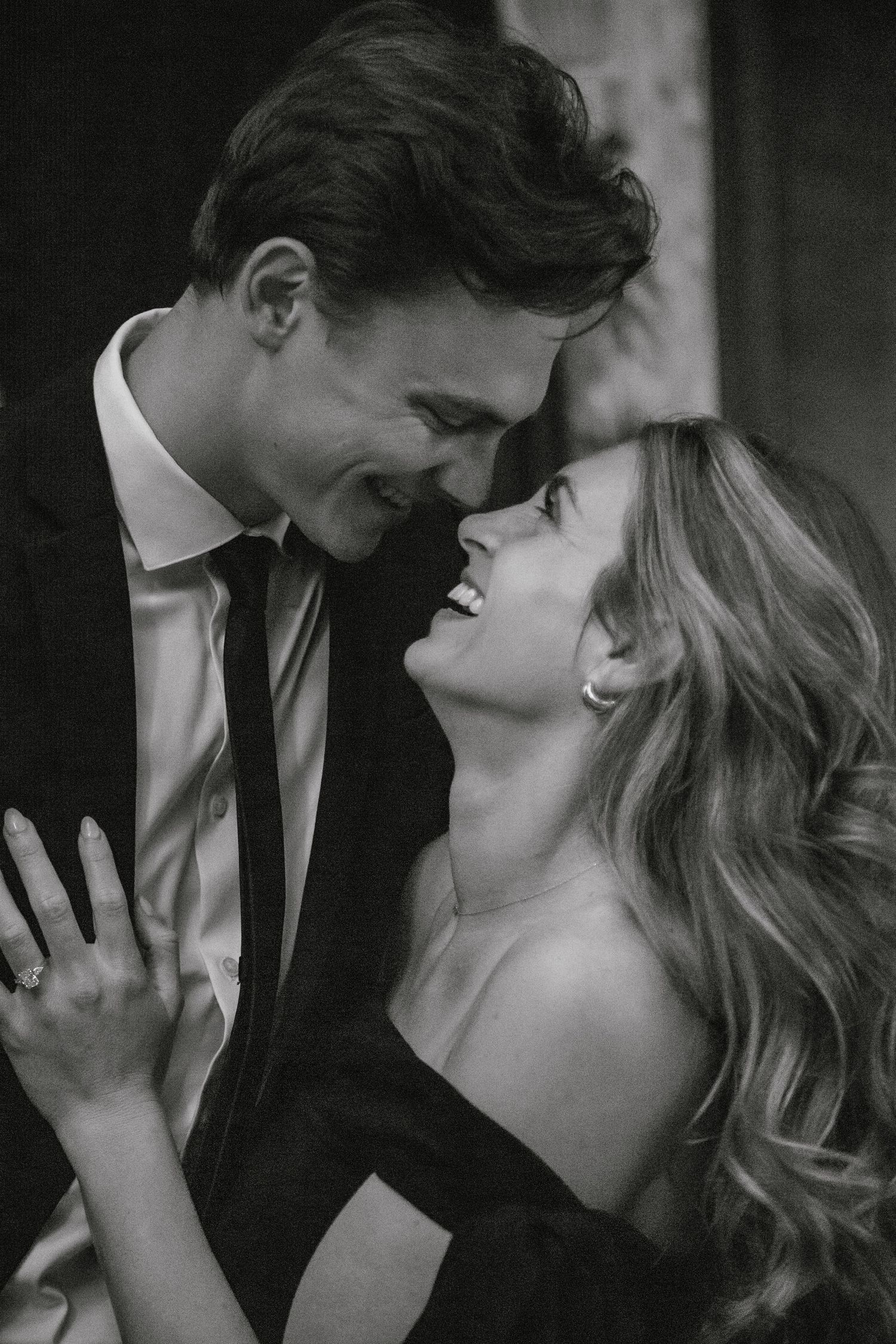 engaged couple laughing in a bar