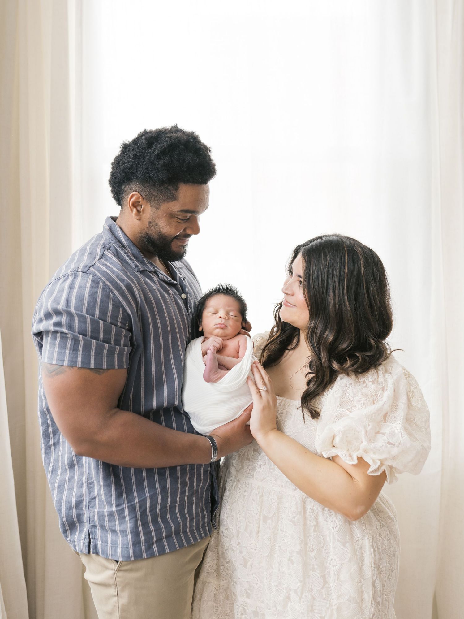 Parent cuddling their baby during a newborn photography session in Valparaiso, Indiana.