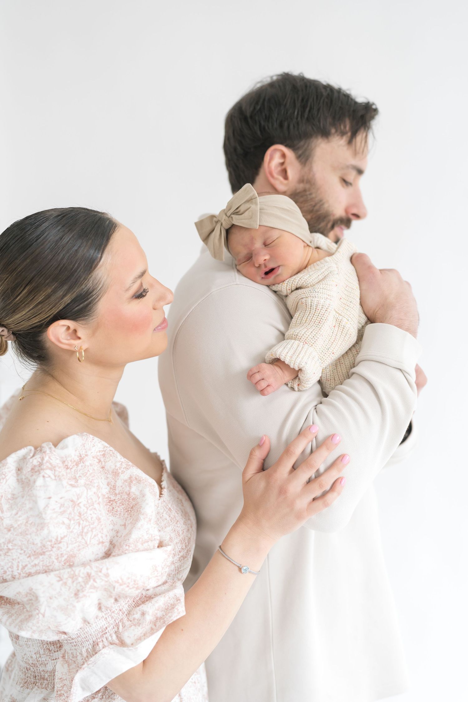 Mom and dad posing with baby during a studio newborn photography session in downtown valparaiso indiana
