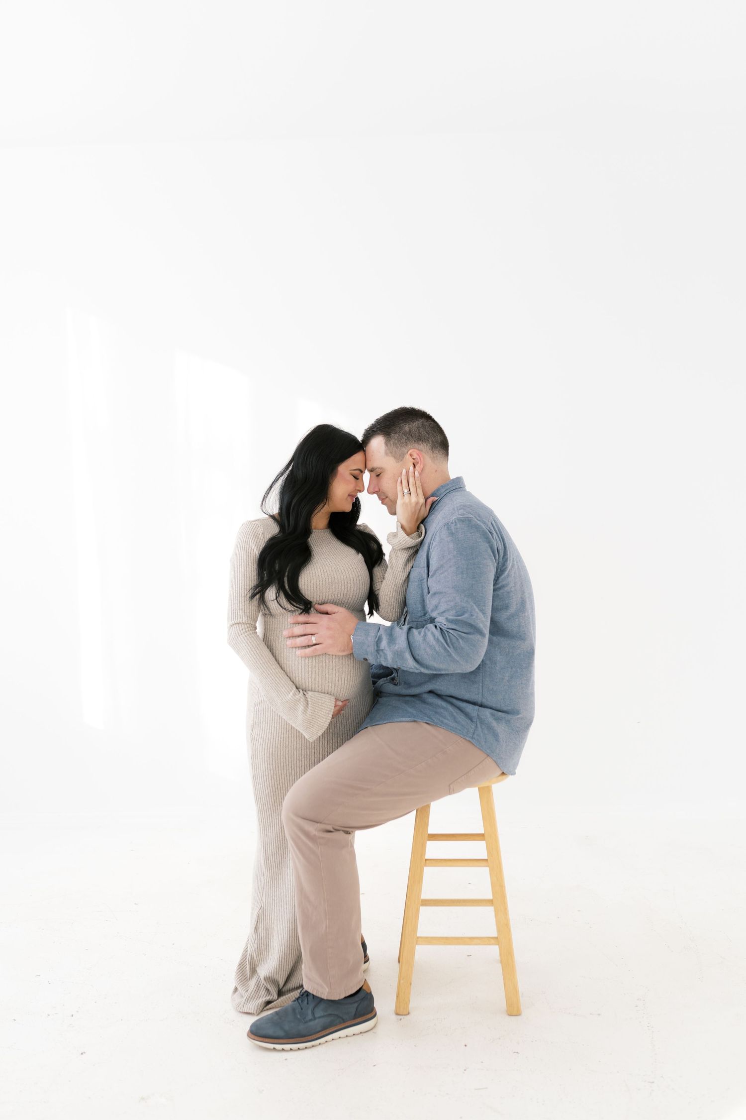 Boudoir maternity photography session in Valparaiso, Indiana with soft light and neutral tones.