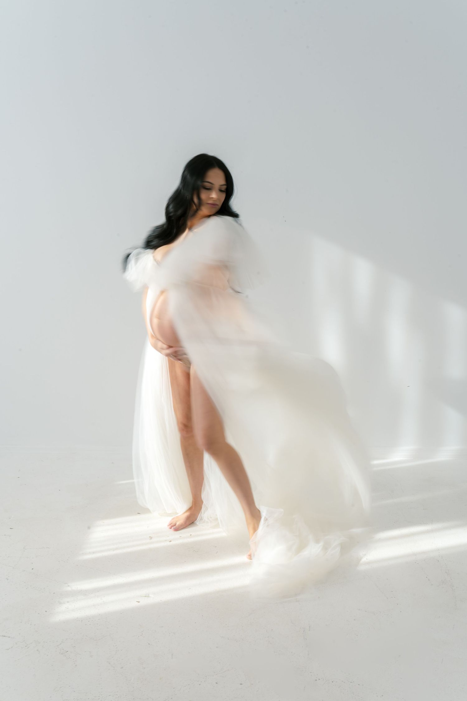 Expecting mother celebrating pregnancy during a boudoir maternity studio session near Chicago.