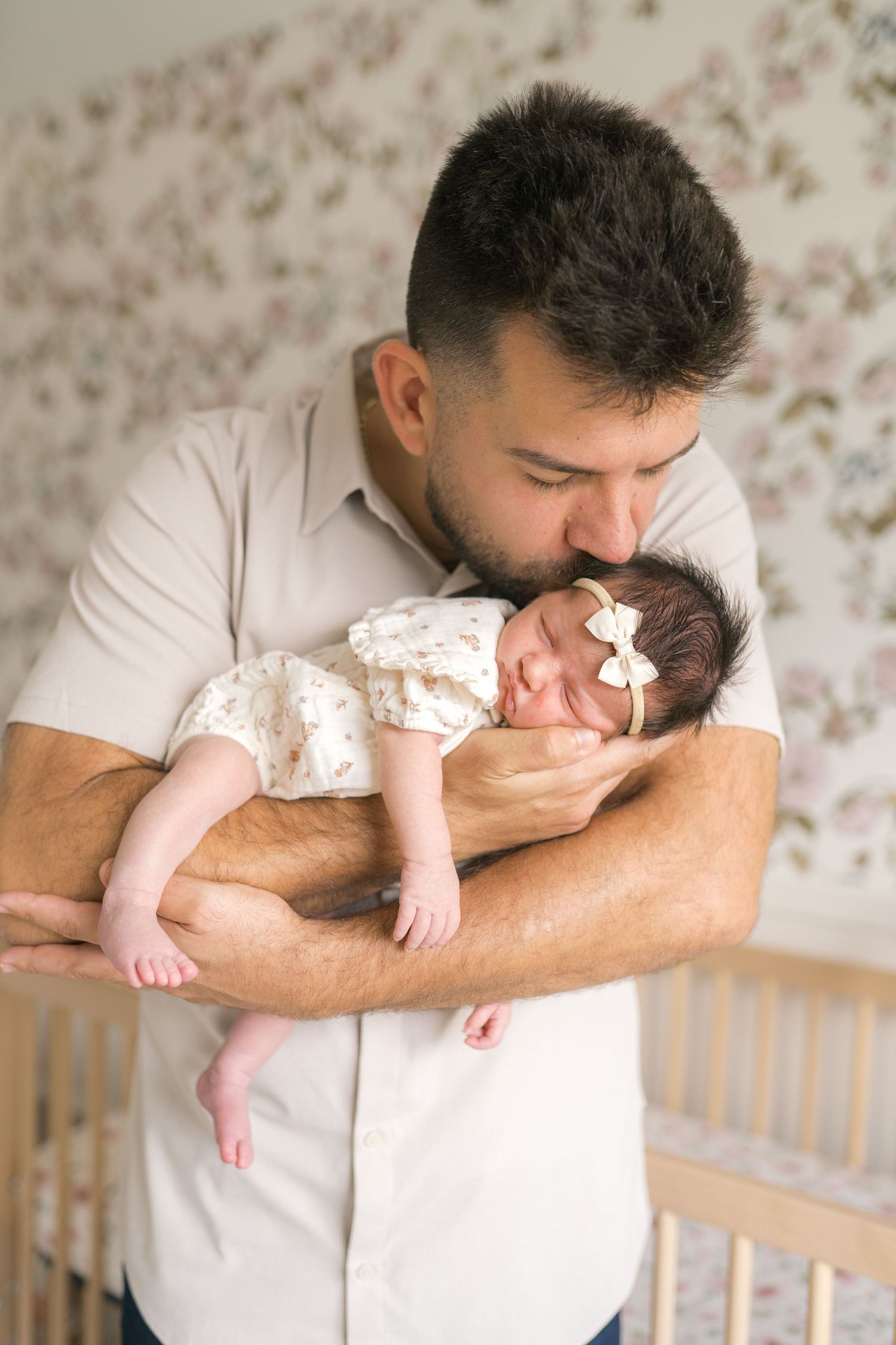 Newborn baby resting in parents’ arms during an in-home session in Northwest Indiana.