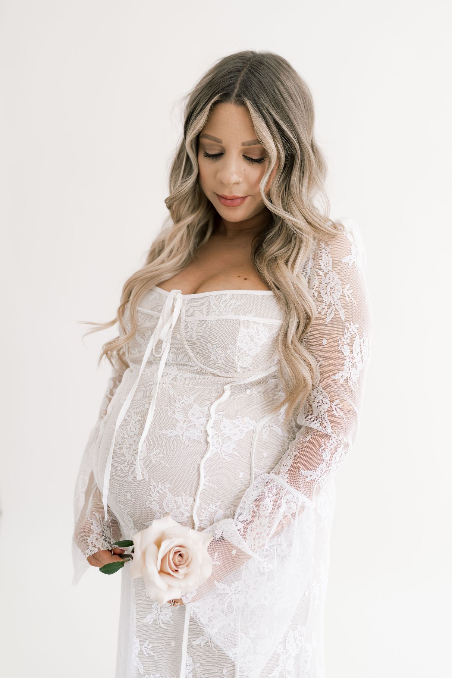 Expecting mother embracing her baby bump during an intimate maternity session in Valparaiso, Indiana.