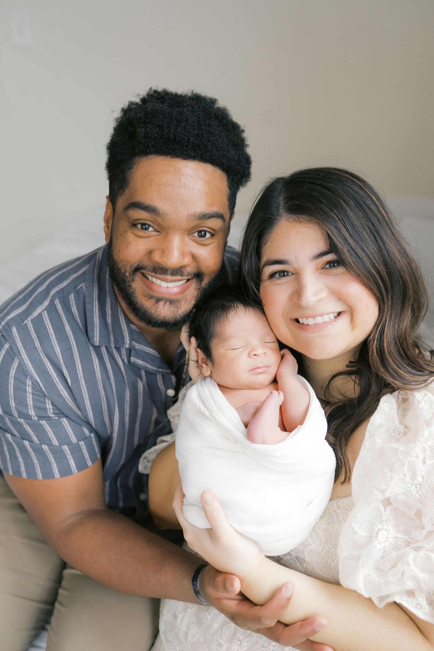 Parent cuddling their baby during a newborn photography session in Valparaiso, Indiana.