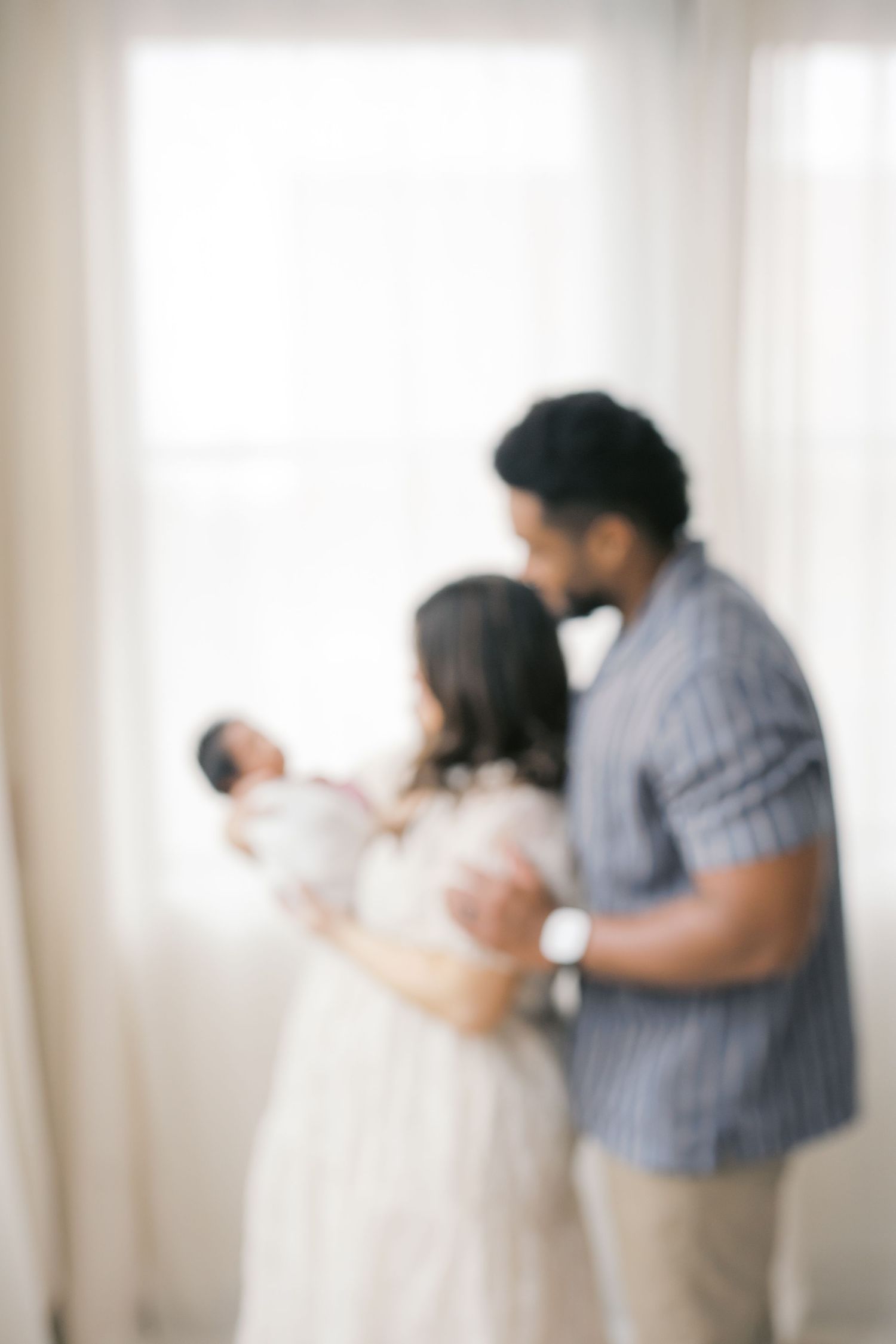 Parent cuddling their baby during a newborn photography session in Valparaiso, Indiana.