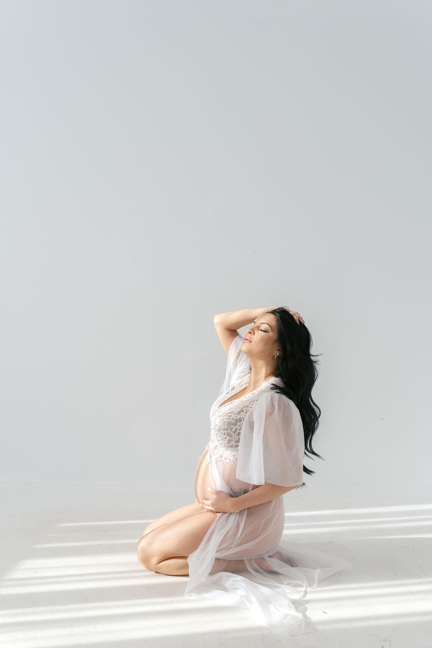 Empowering boudoir maternity session celebrating the beauty of pregnancy near Chicago.