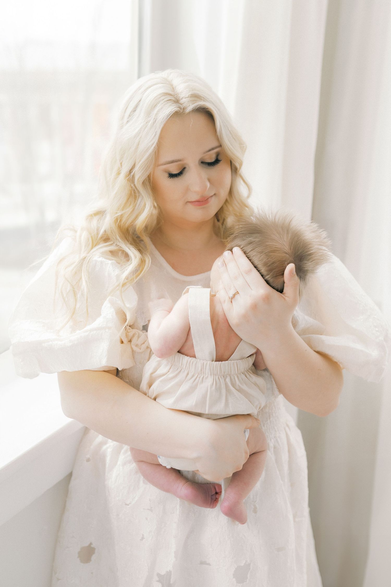 Mom holding baby during newborn photo session in downtown valparaiso