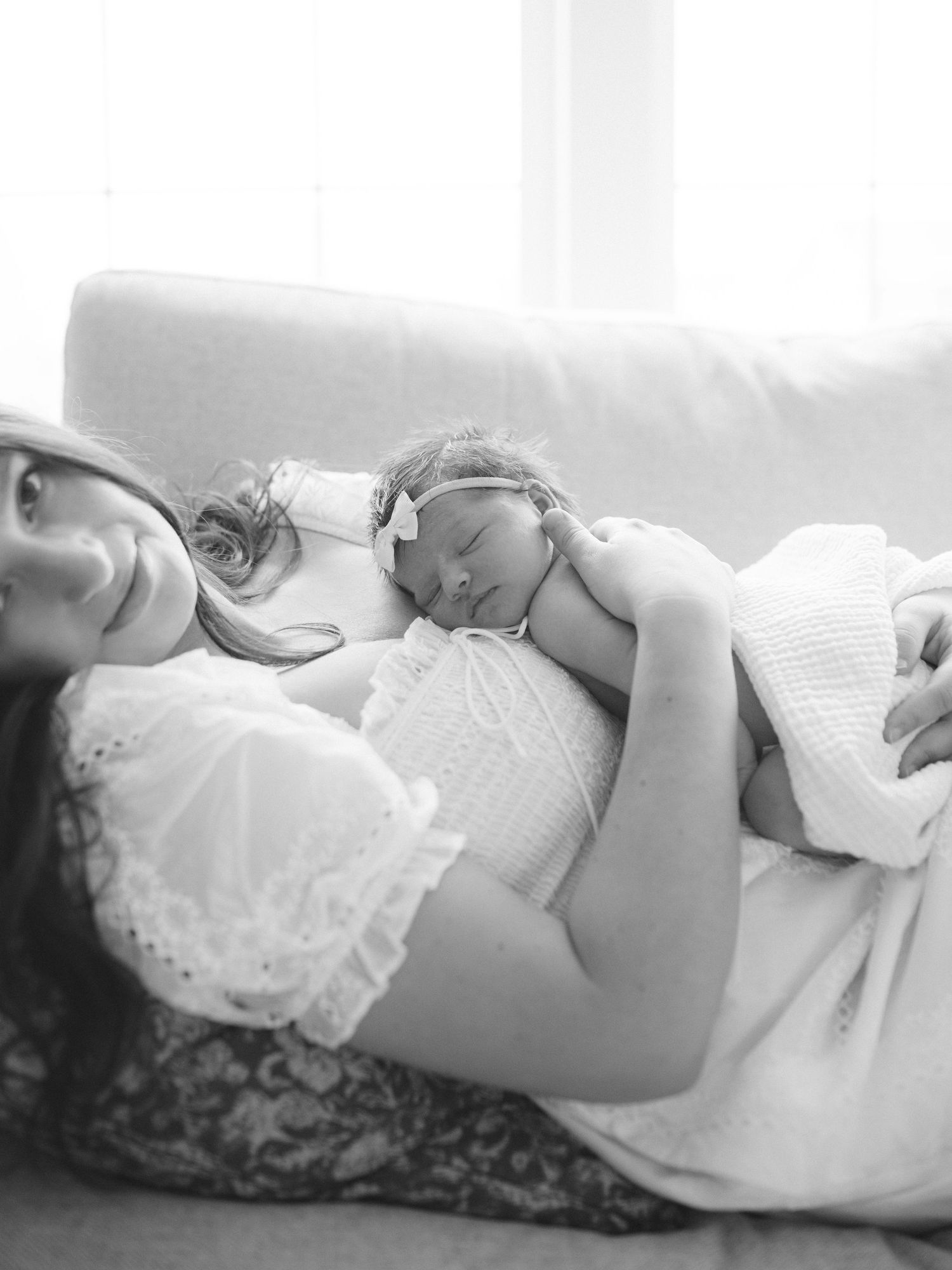 Baby cuddles with mom, at home newborn session, near Chicago