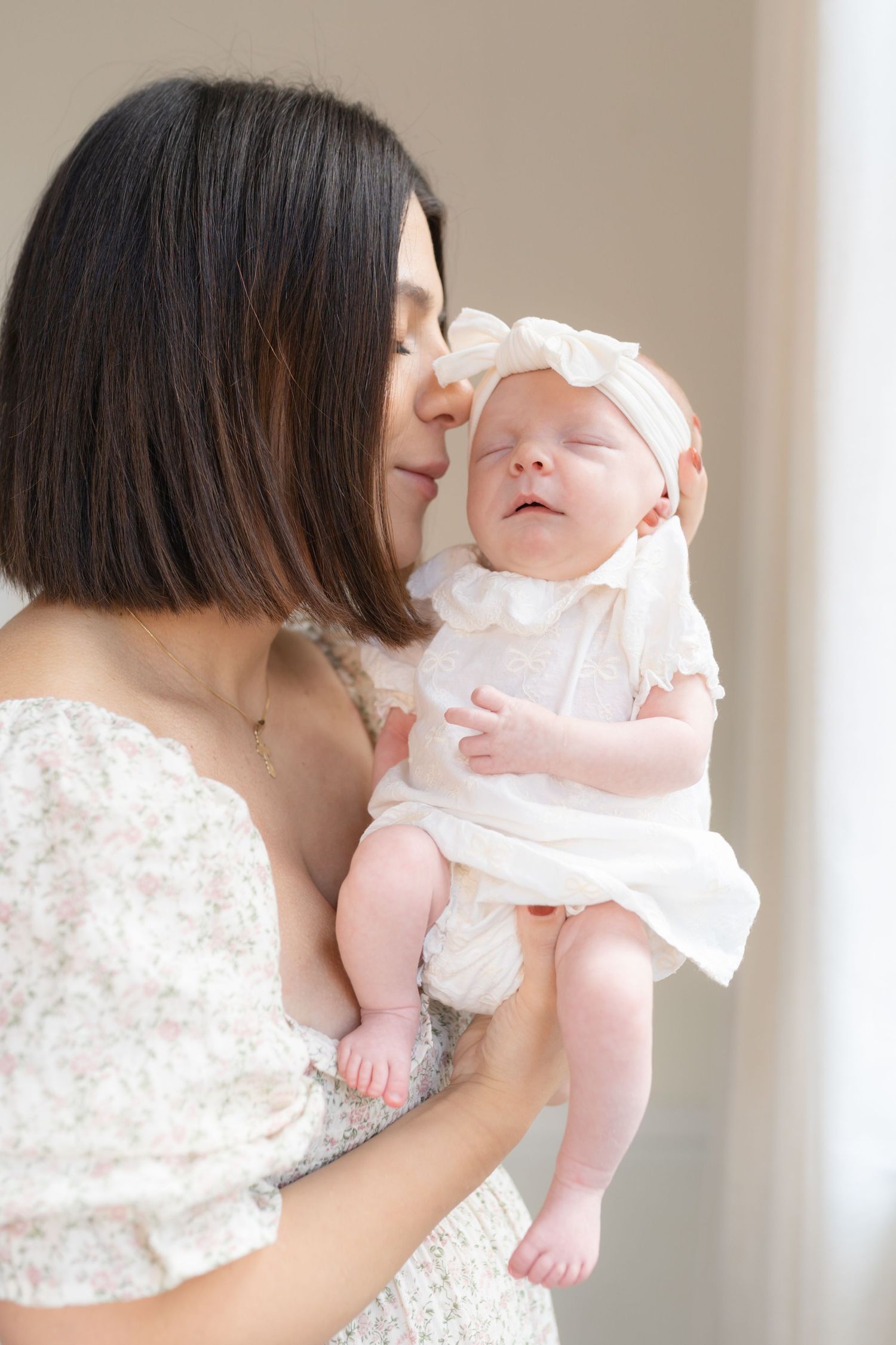 New mother holding her newborn baby during an intimate studio newborn session in Valparaiso, Indiana.