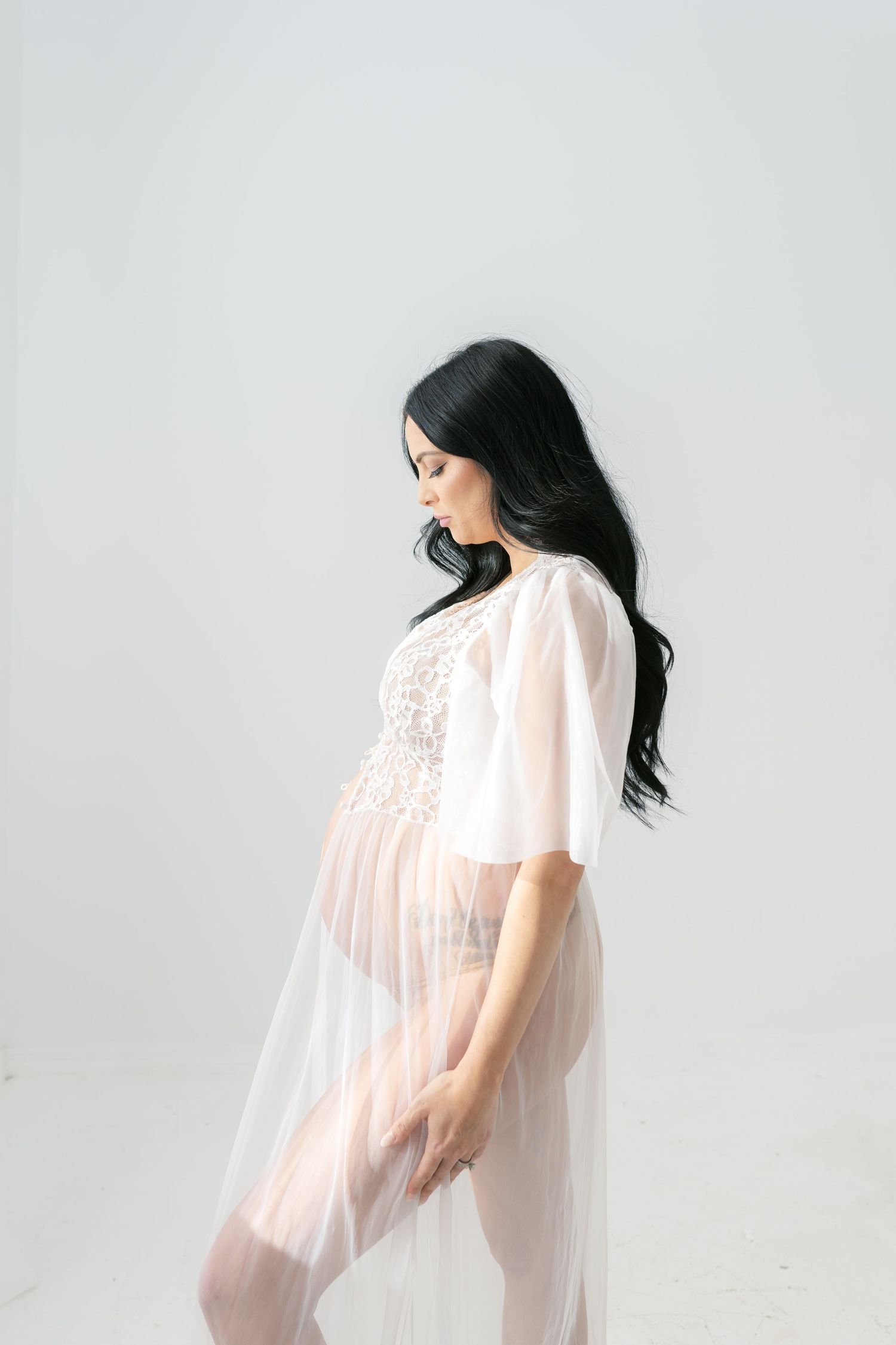 Private studio boudoir maternity session in Valparaiso, Indiana for expecting mothers.