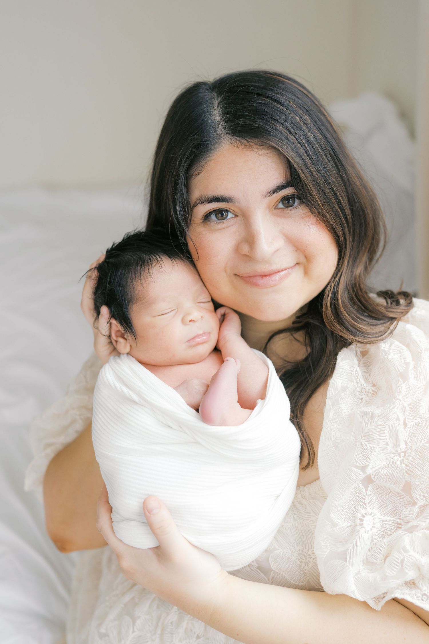 New mother holding her newborn baby during an intimate studio newborn session in Valparaiso, Indiana.