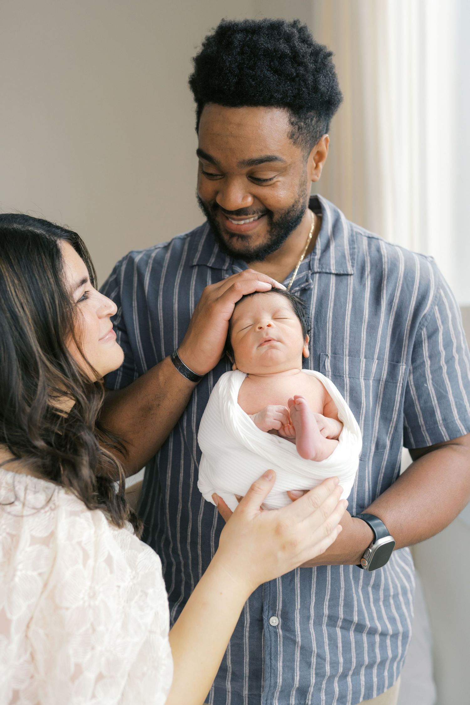 Parent cuddling their baby during a newborn photography session in Valparaiso, Indiana.