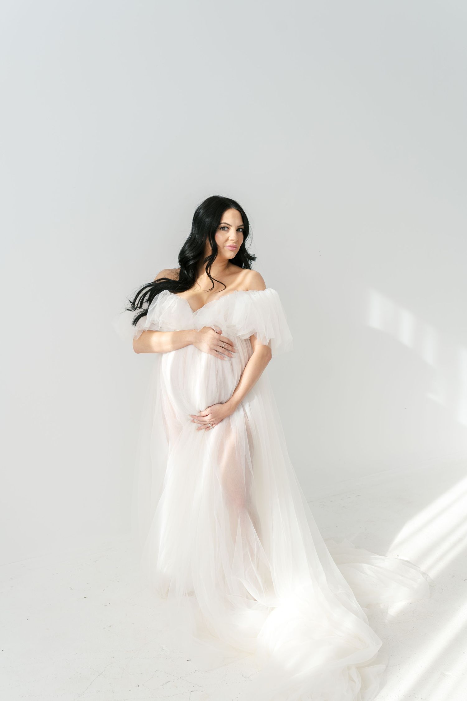 Expecting mother celebrating pregnancy during a boudoir maternity studio session near Chicago.