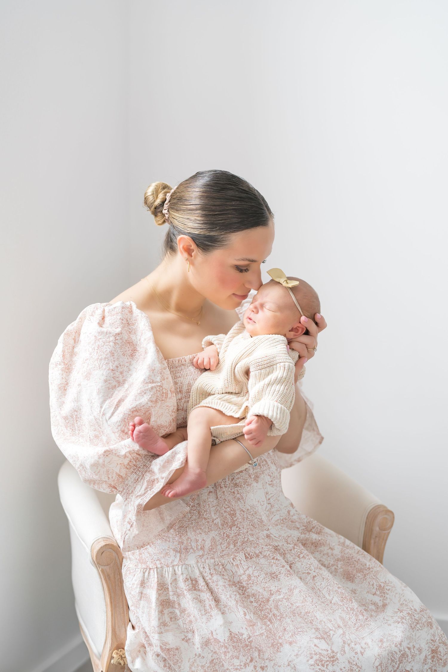 Mother cuddling with baby during a studio newborn photography session in downtown valparaiso indiana