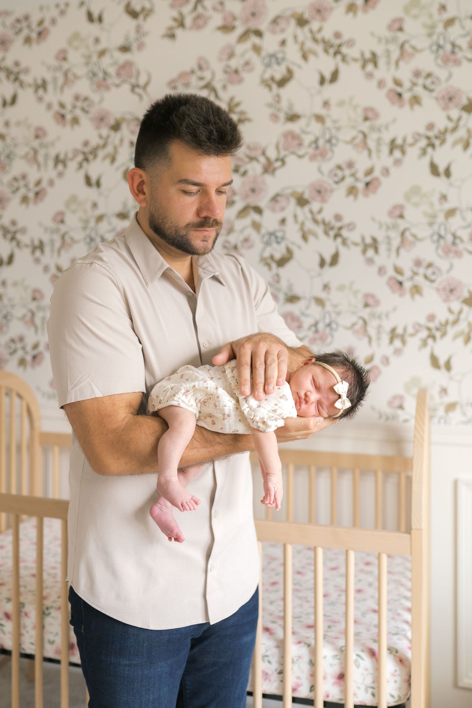 Newborn baby resting in parents’ arms during an in-home session in Northwest Indiana.