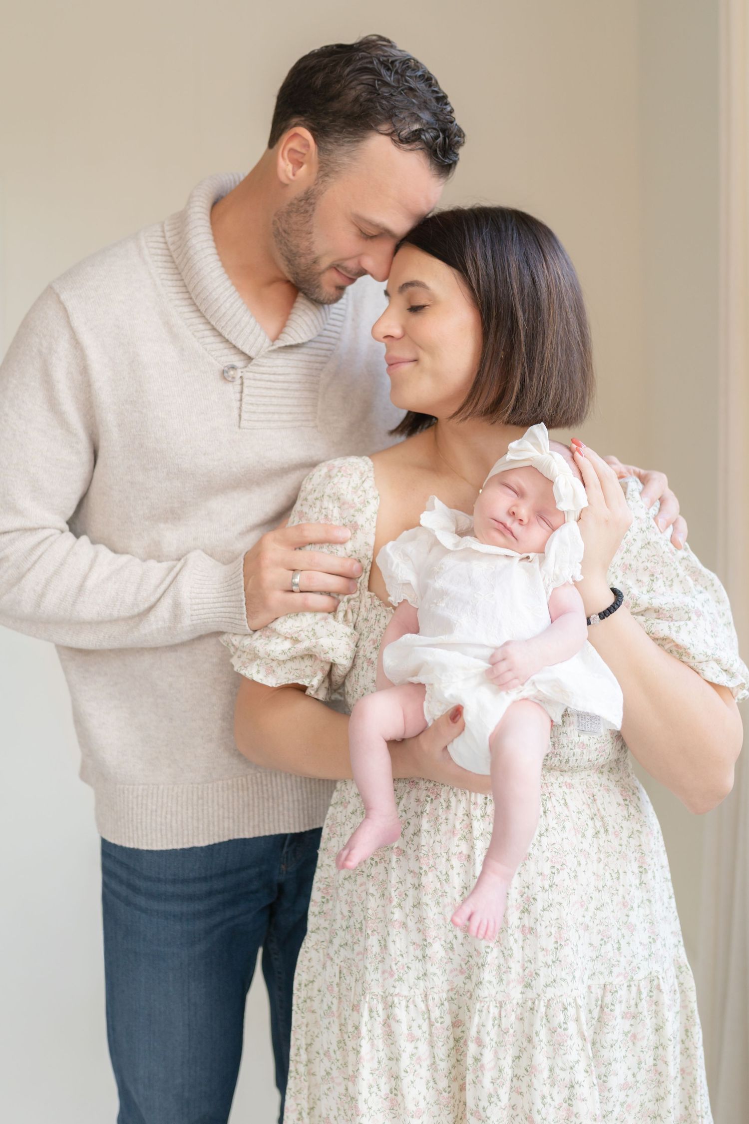 Emotional newborn photography capturing the bond between mother, father, and baby in a Valparaiso studio.