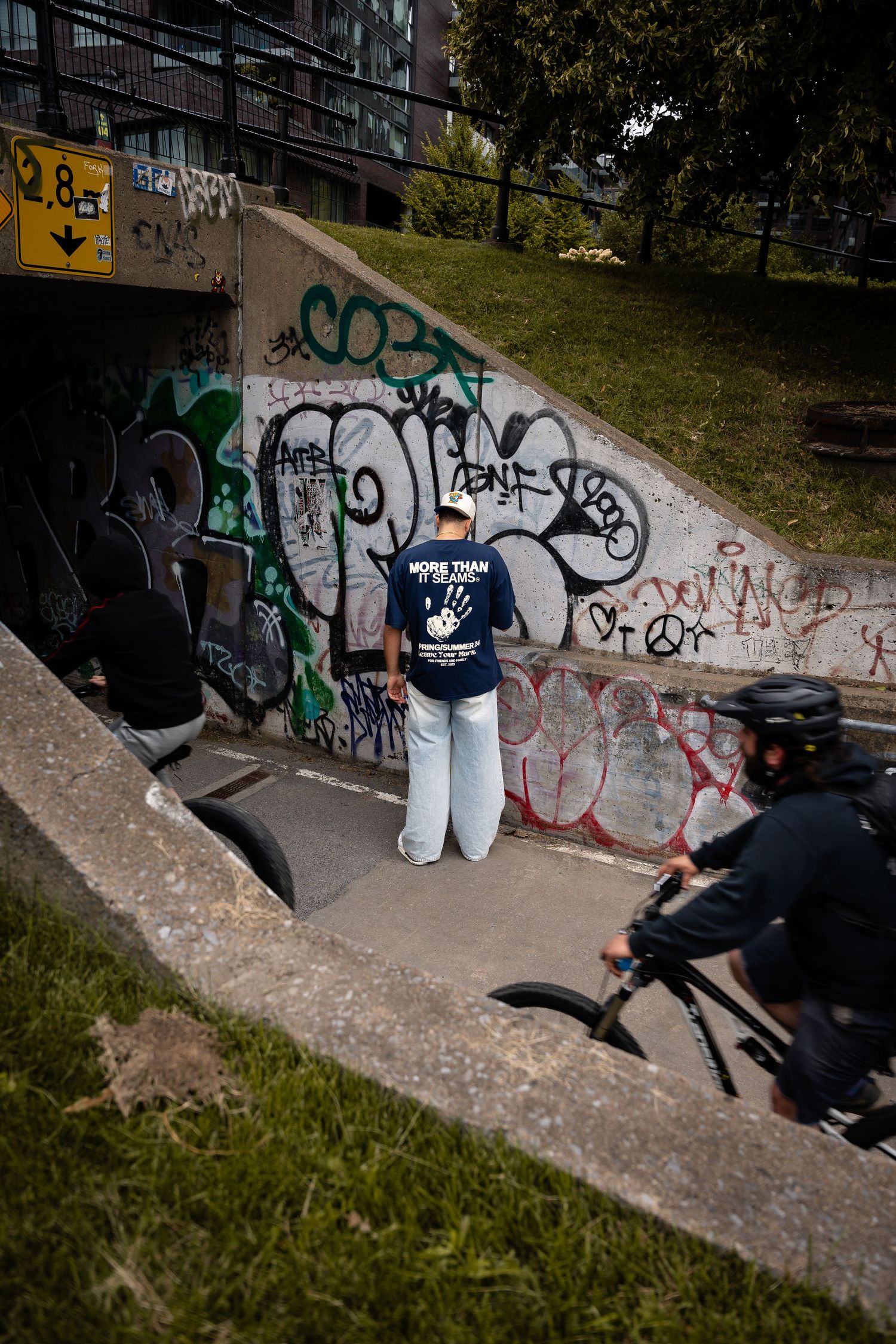 Sequence of skateboarding tricks performed near a graffiti-covered wall.