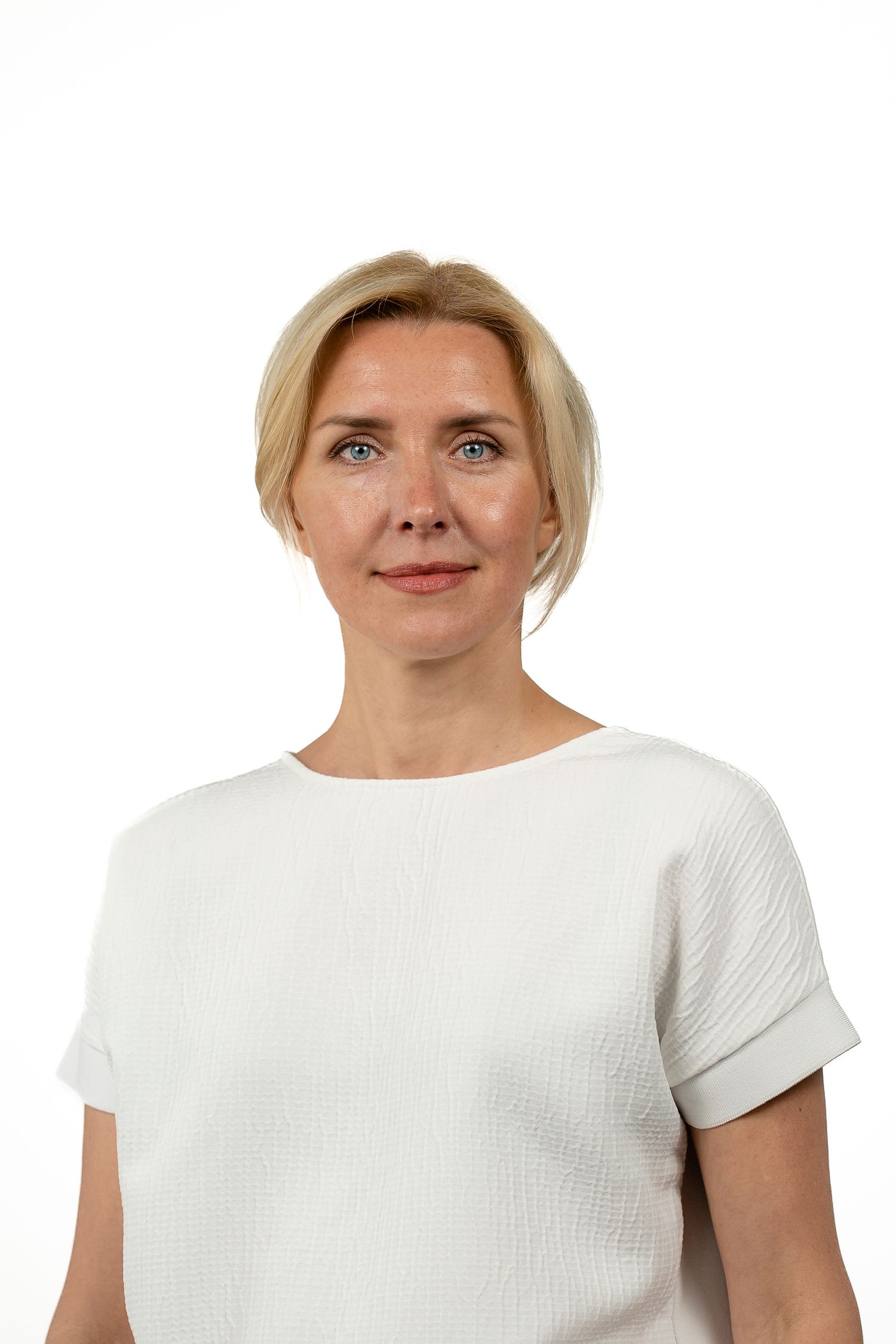 Portrait series showing different angles in white attire against plain background.