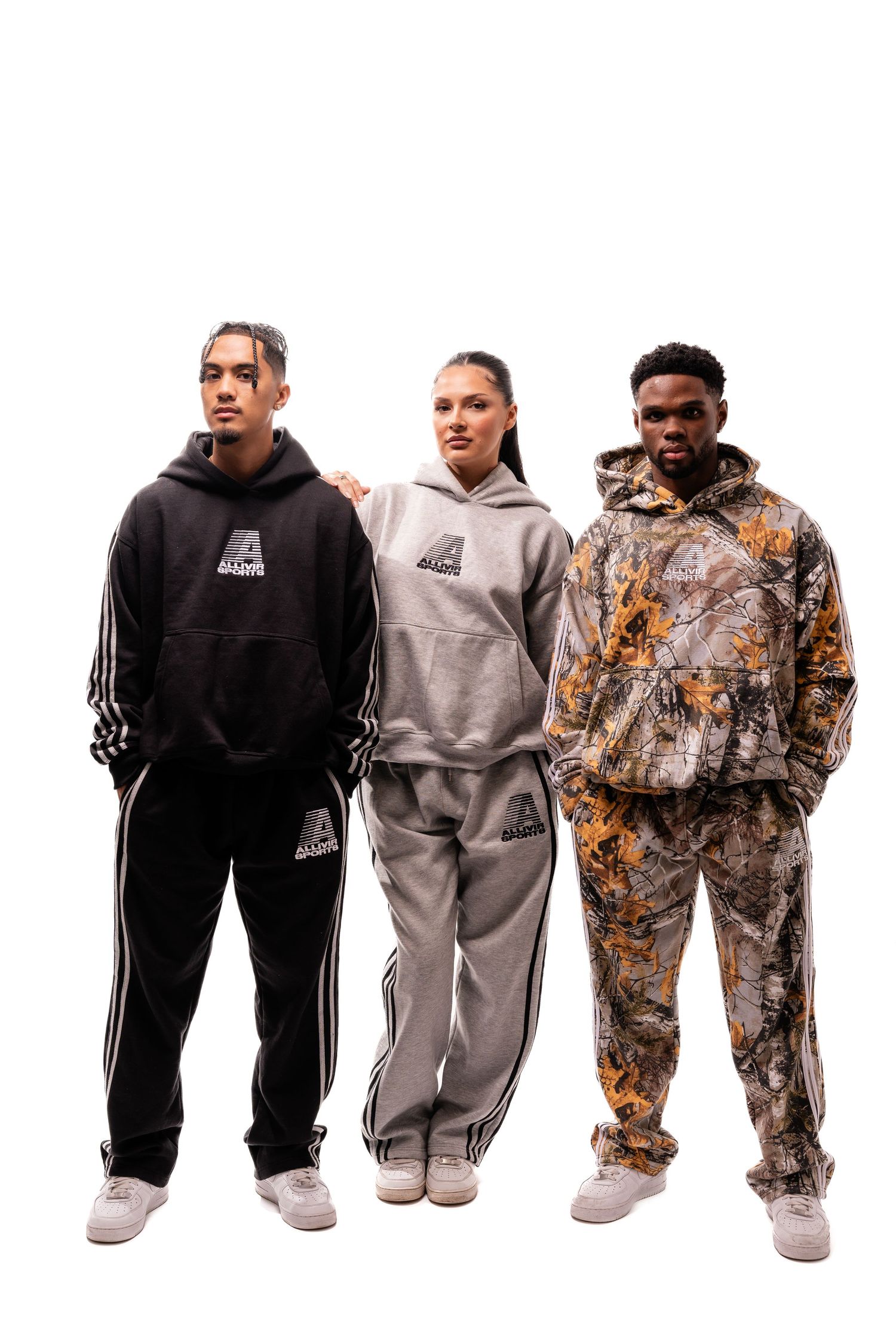 Collection of athletic sweatsuits in black, grey, and camouflage patterns shown together.