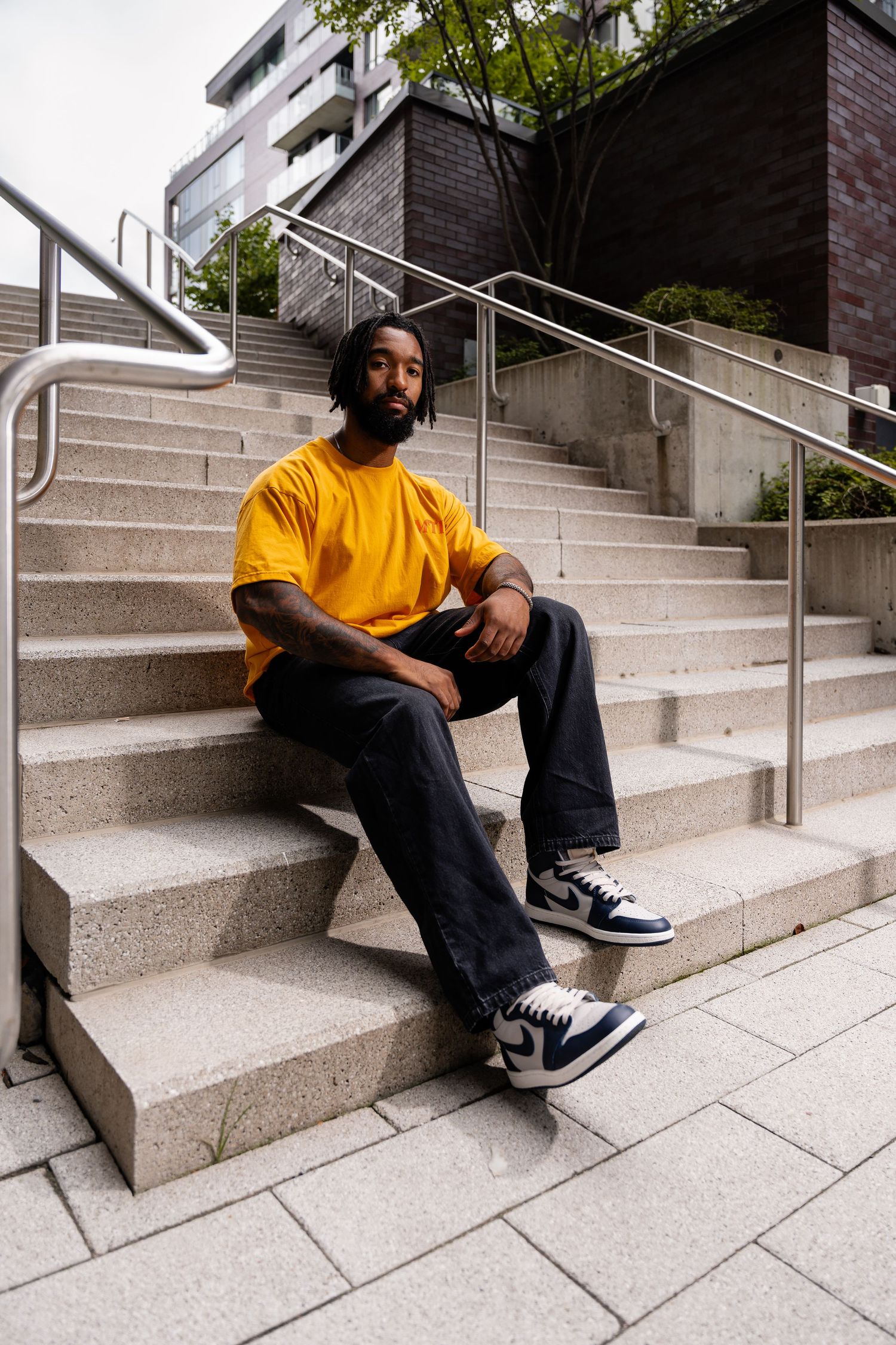 Series of skateboarding poses on concrete steps with metal handrails.