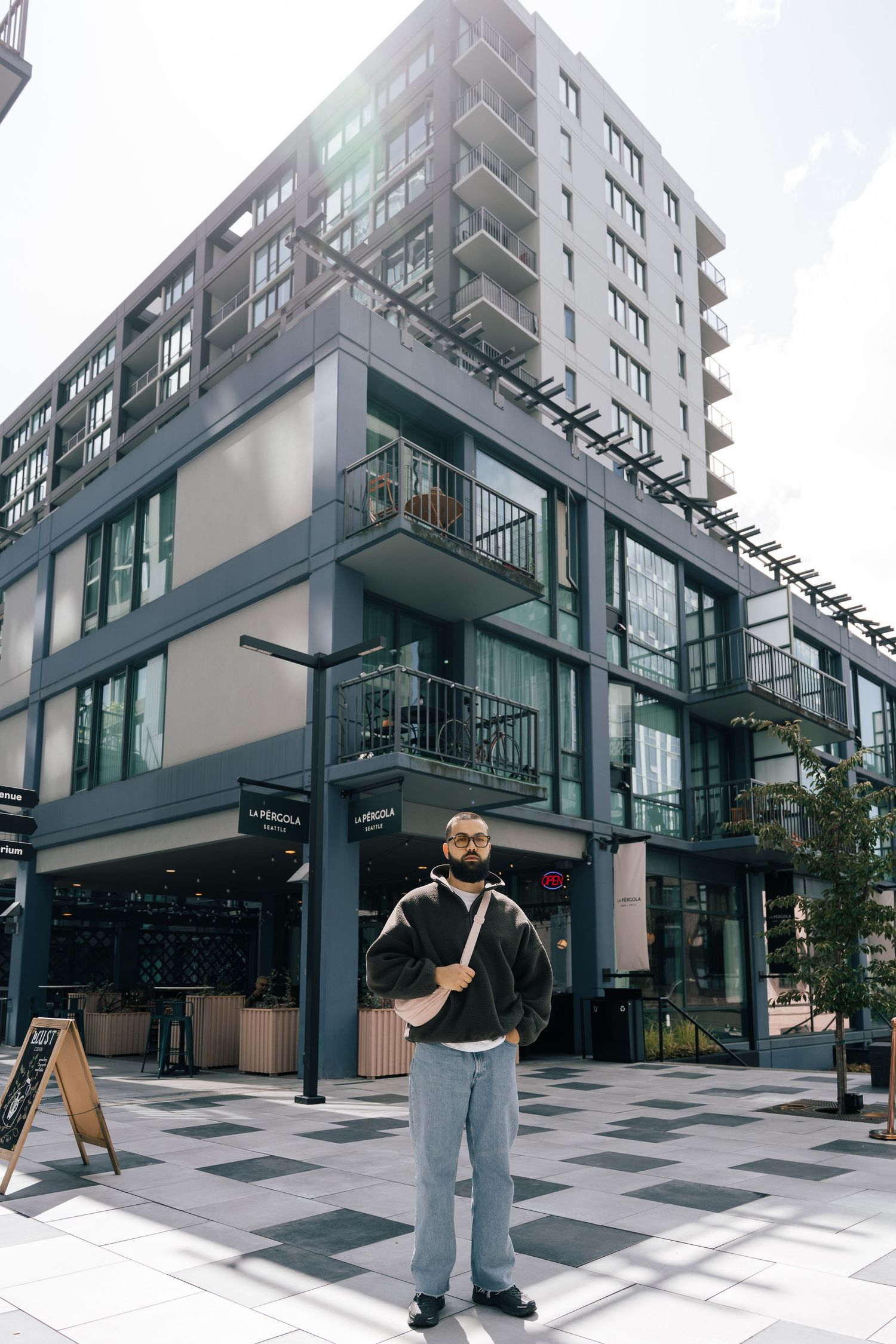Modern apartment building exterior with geometric glass and metal architecture.