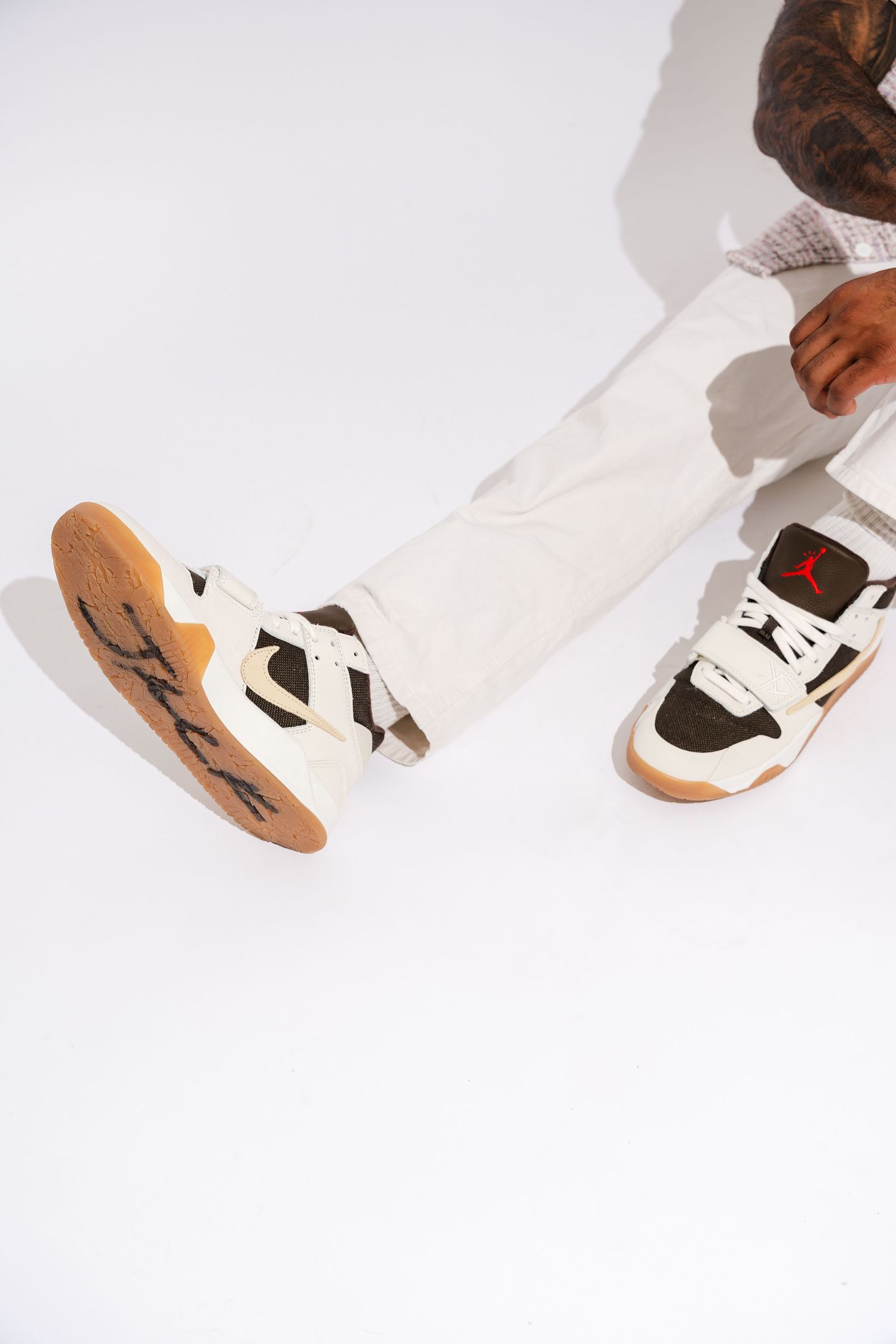 Detail shots of black and white sneakers with brown soles against white background.