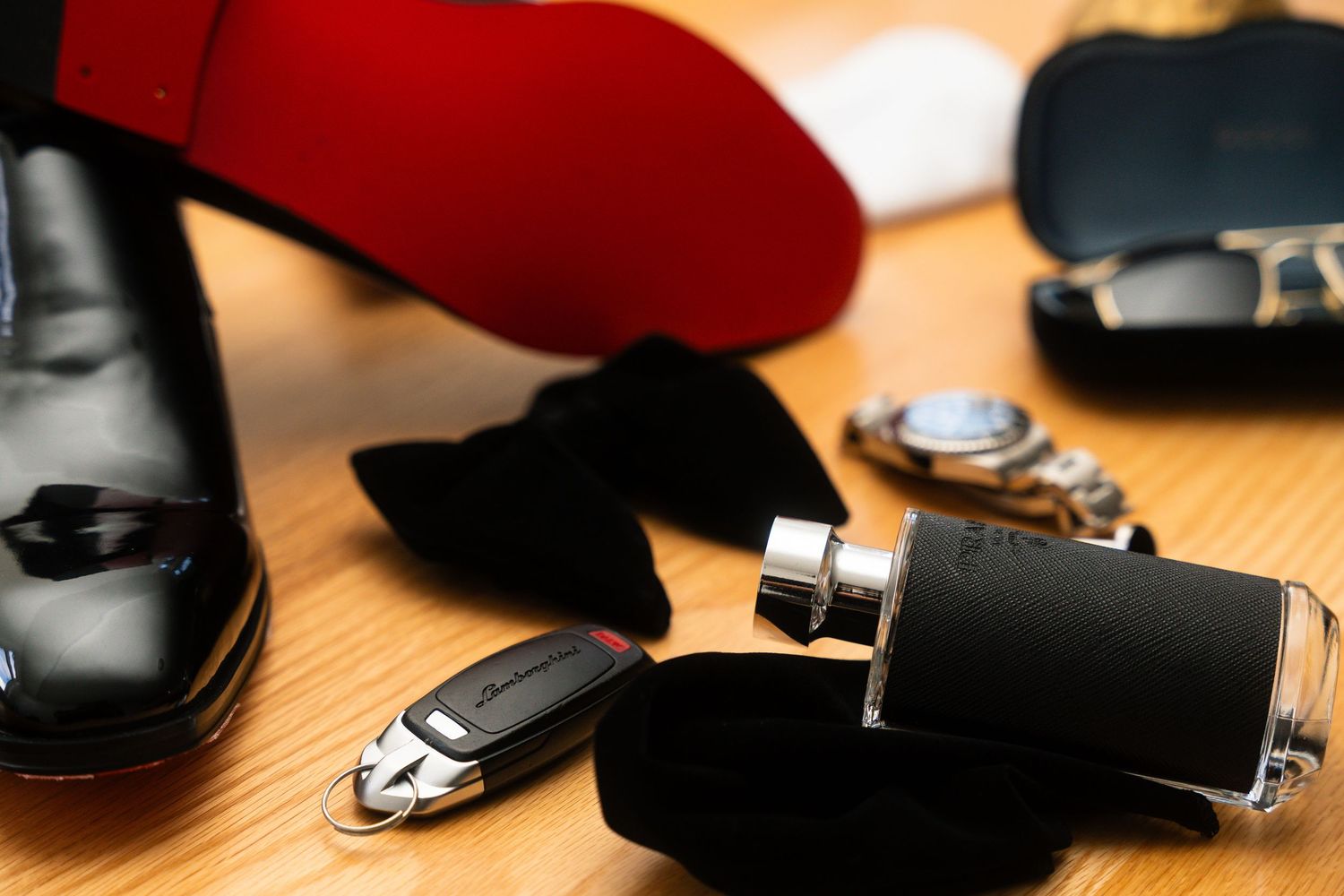 Close-up view of black car keys and remote fob on a wooden surface in natural lighting.