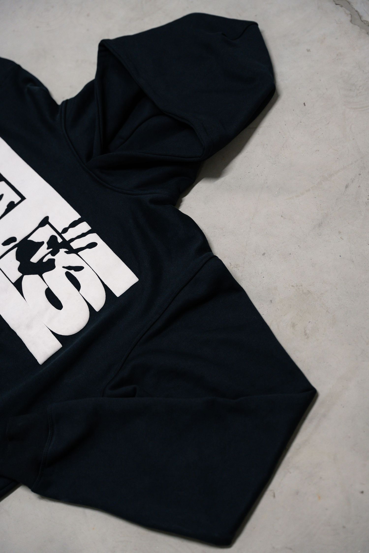 Black hoodie with white graphic design shown from multiple angles on gray background.