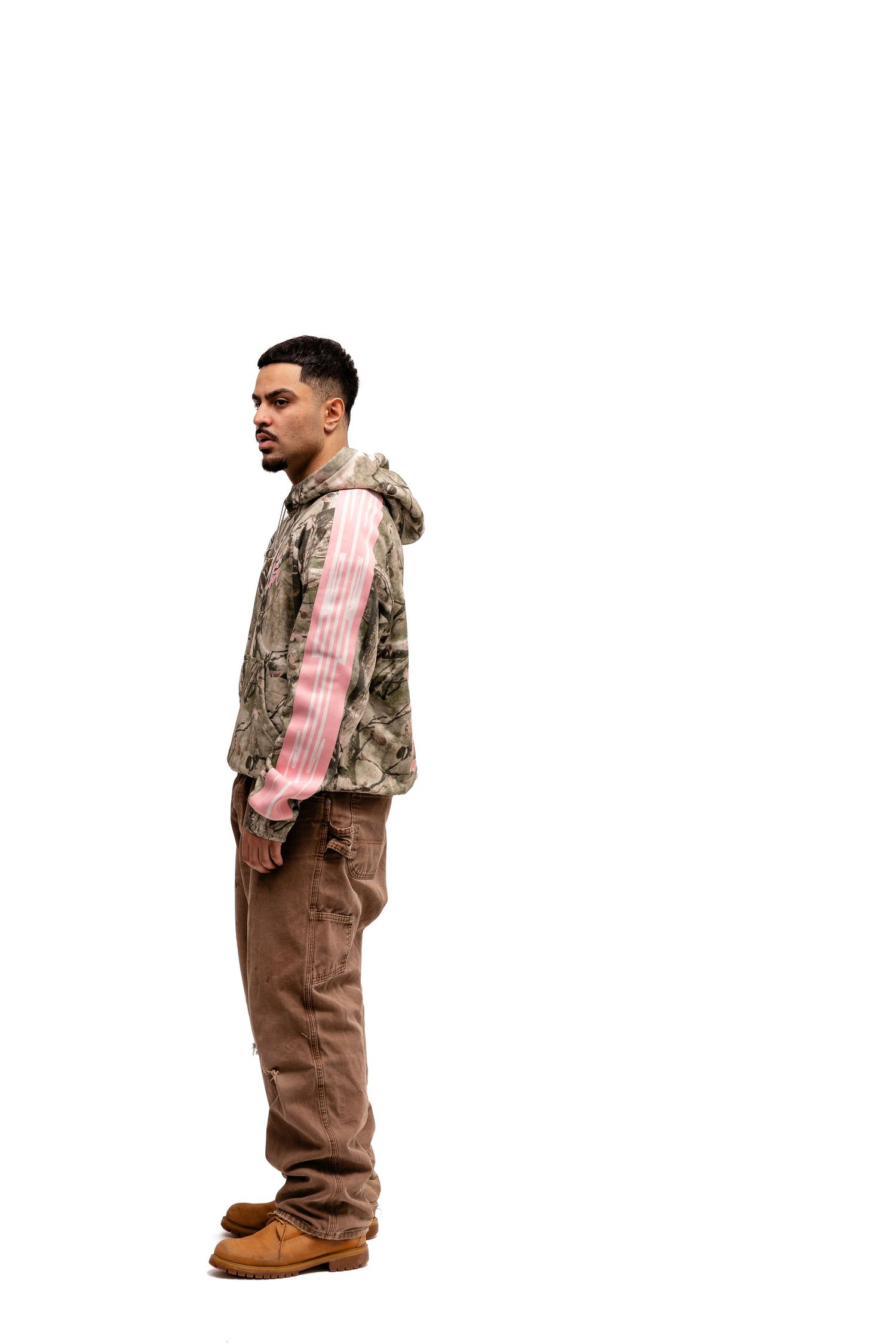 Camouflage and pink streetwear outfit displayed in multiple poses.