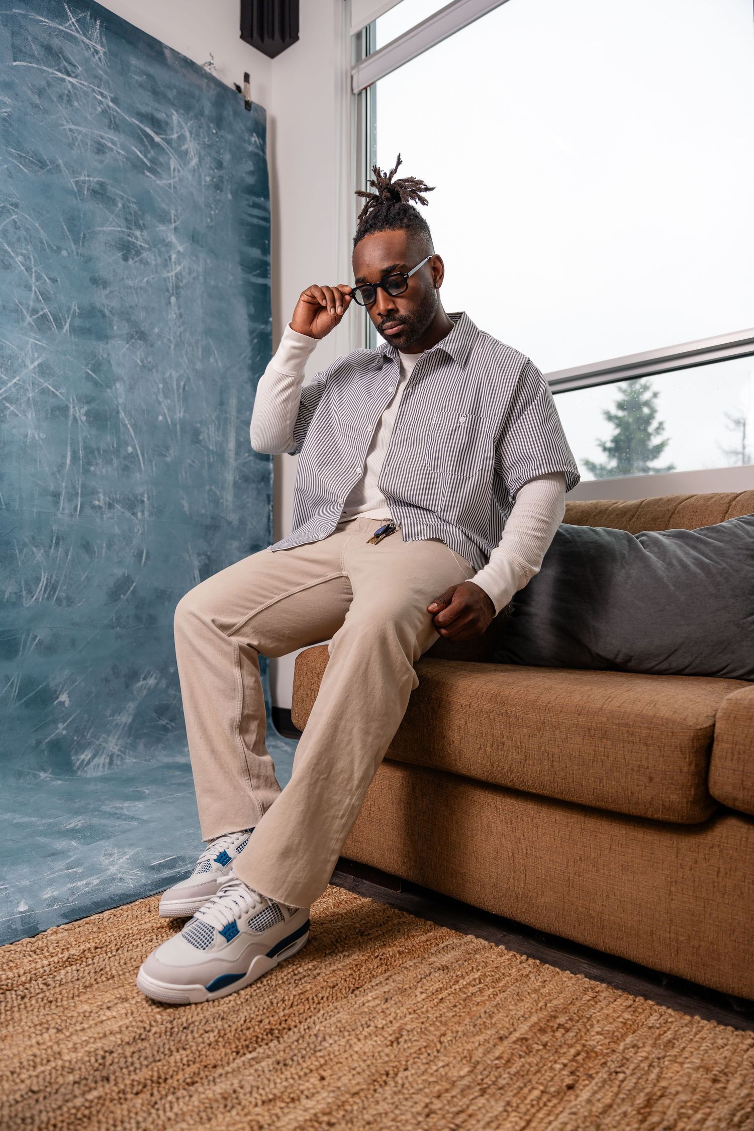 Lifestyle photos showing relaxed poses on brown couch with natural lighting.