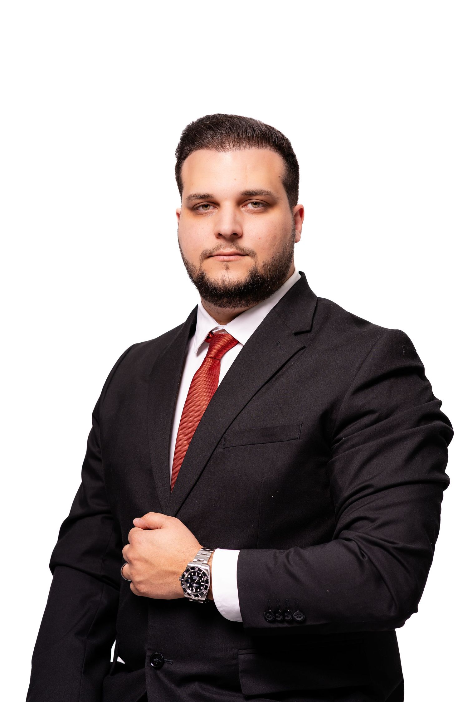Professional headshots showing person in black suit with red tie against white backdrop.