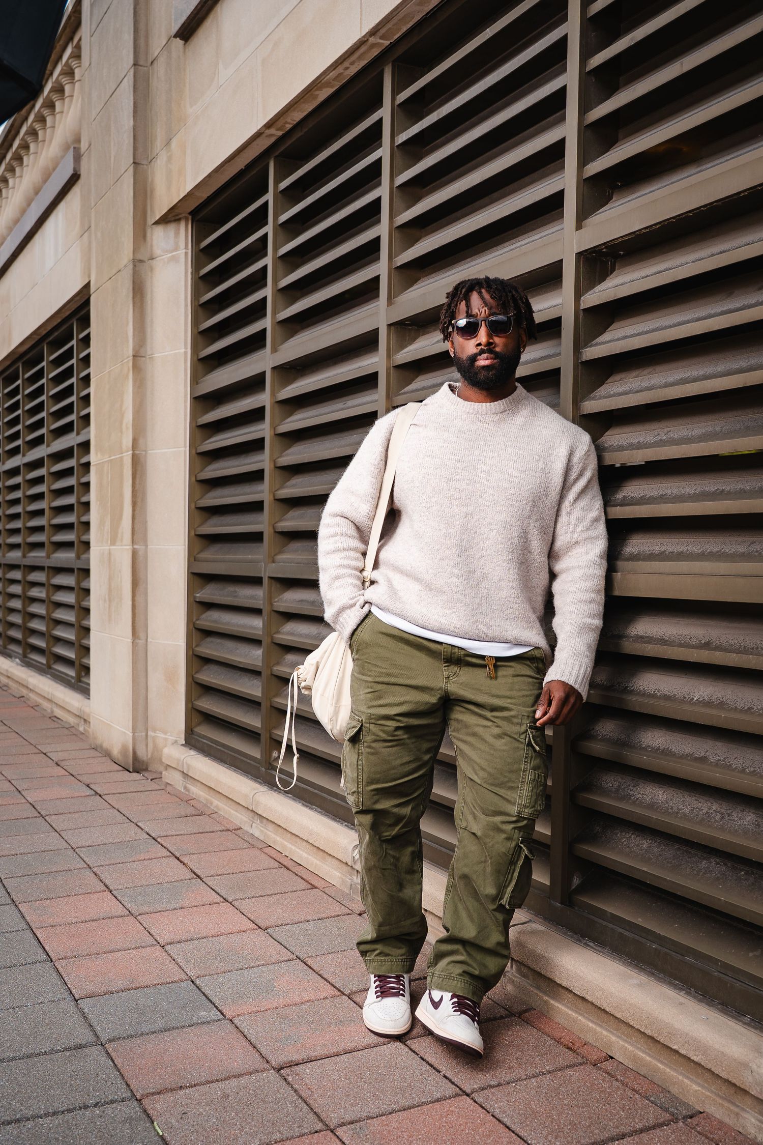 Fashion photo series against architectural wall with louvered windows.
