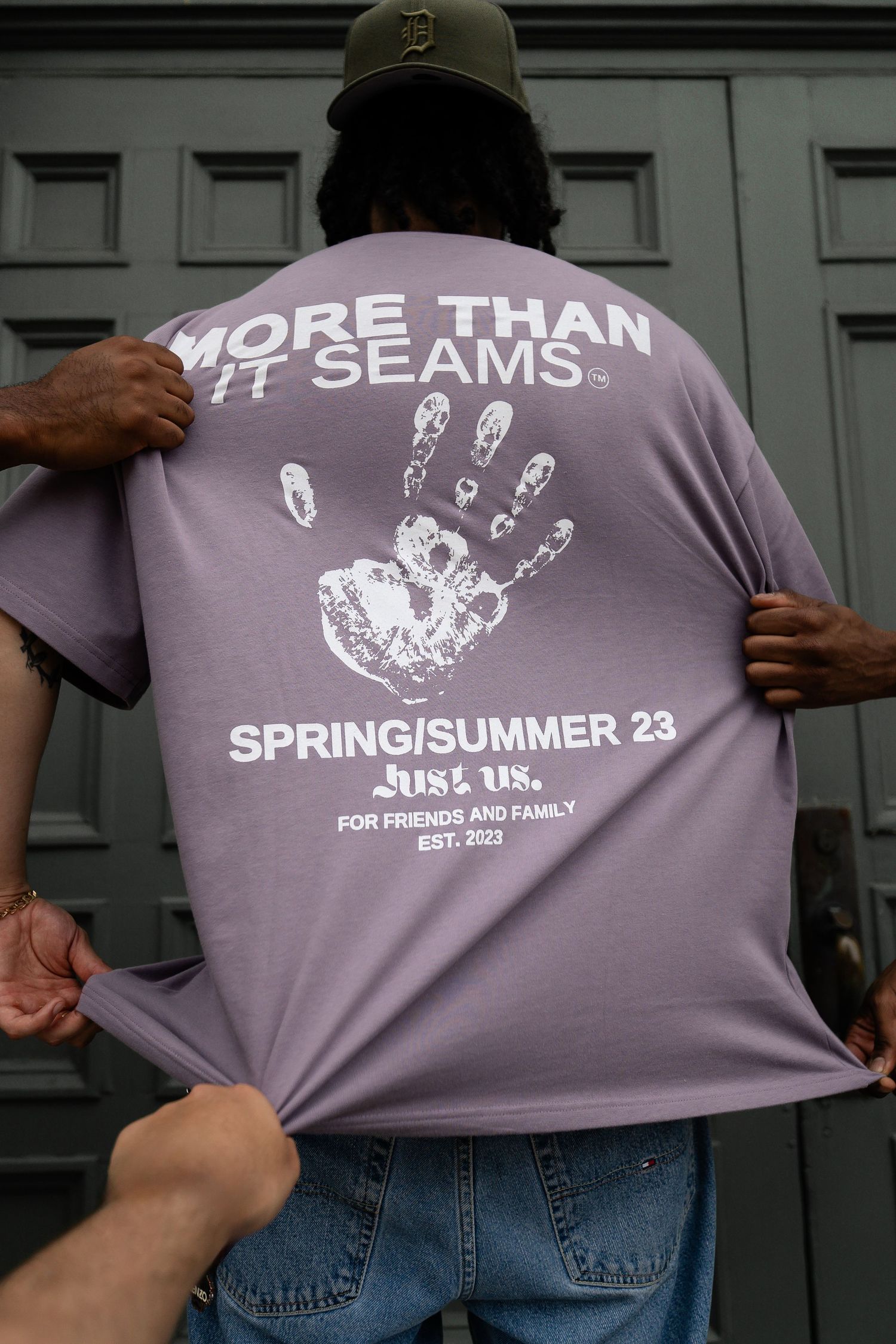 Purple t-shirt design with handprint graphics and text shown from different angles.