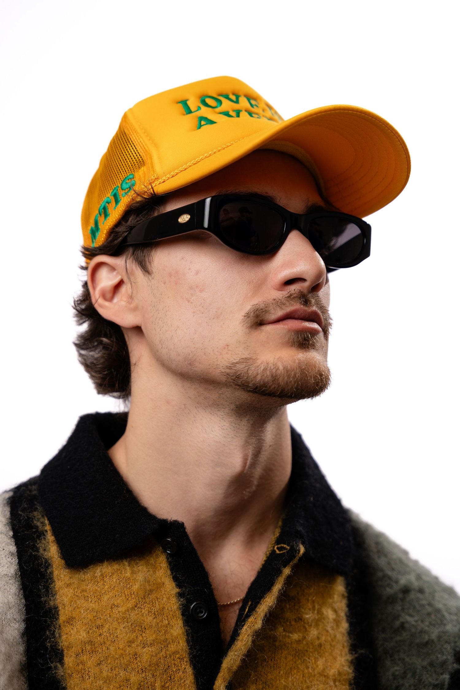 Close-up shots of someone wearing a yellow cap and dark jacket.