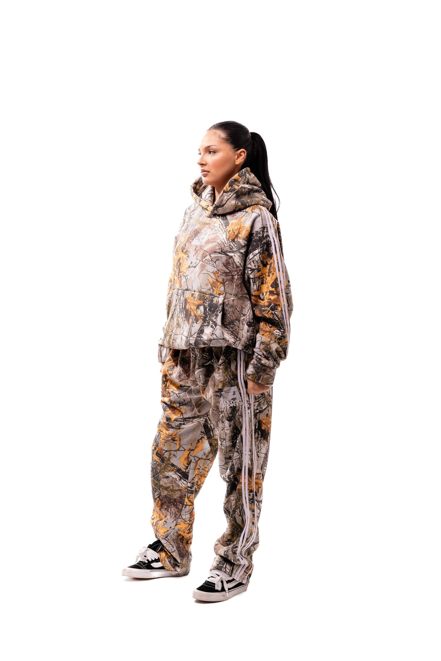 Person modeling camouflage print sweatsuit outfit against white background.
