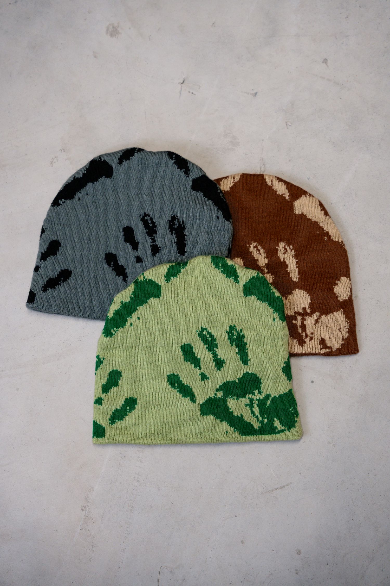 Progressive images of a camo pattern design featuring gray, brown and light green colors.