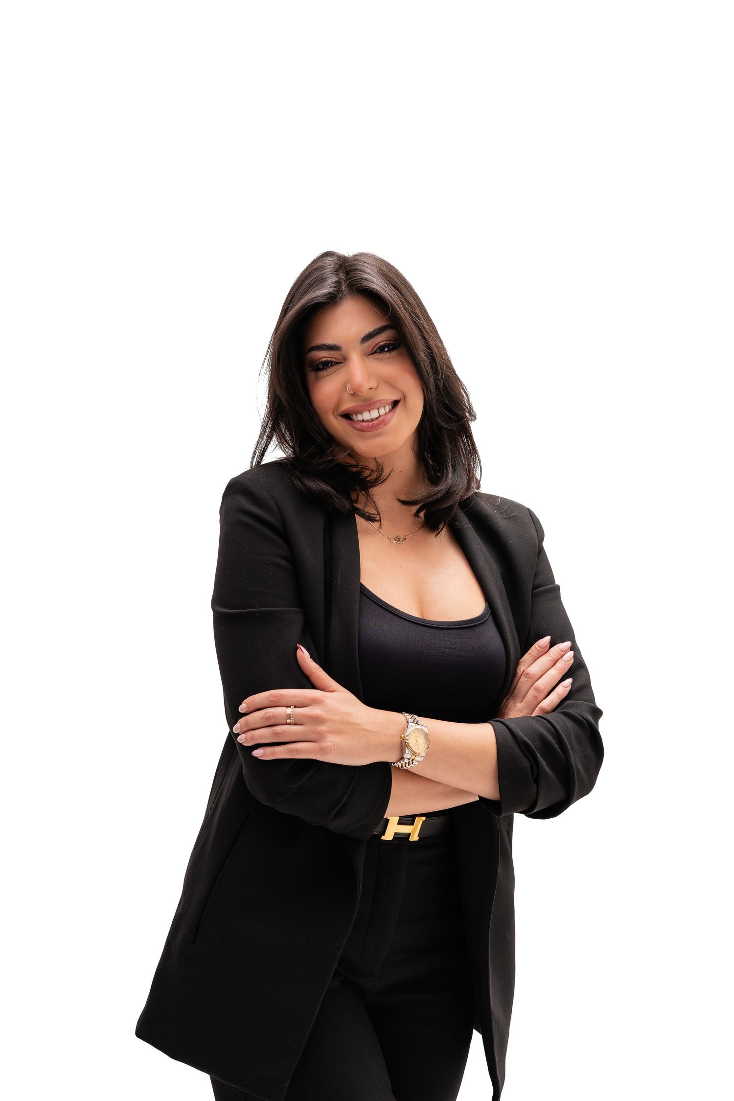 Professional photos of person in black blazer striking confident poses against white backdrop.