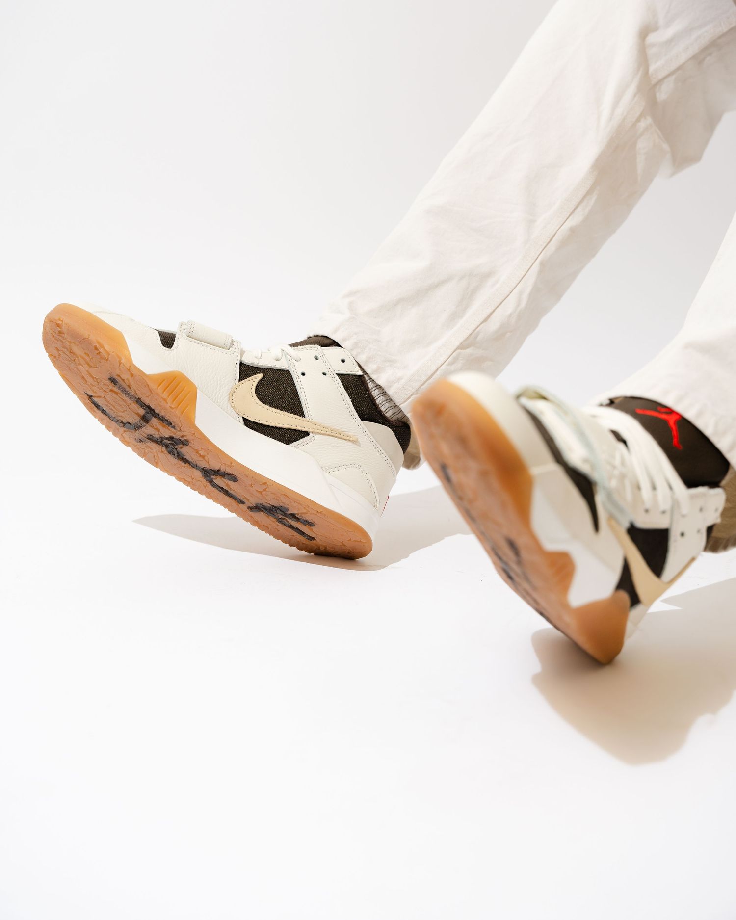 Close-up sequence of white athletic shoes with brown soles against white background.