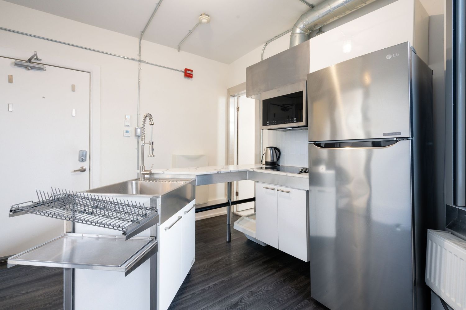 Commercial kitchen with stainless steel counters and professional grade equipment.